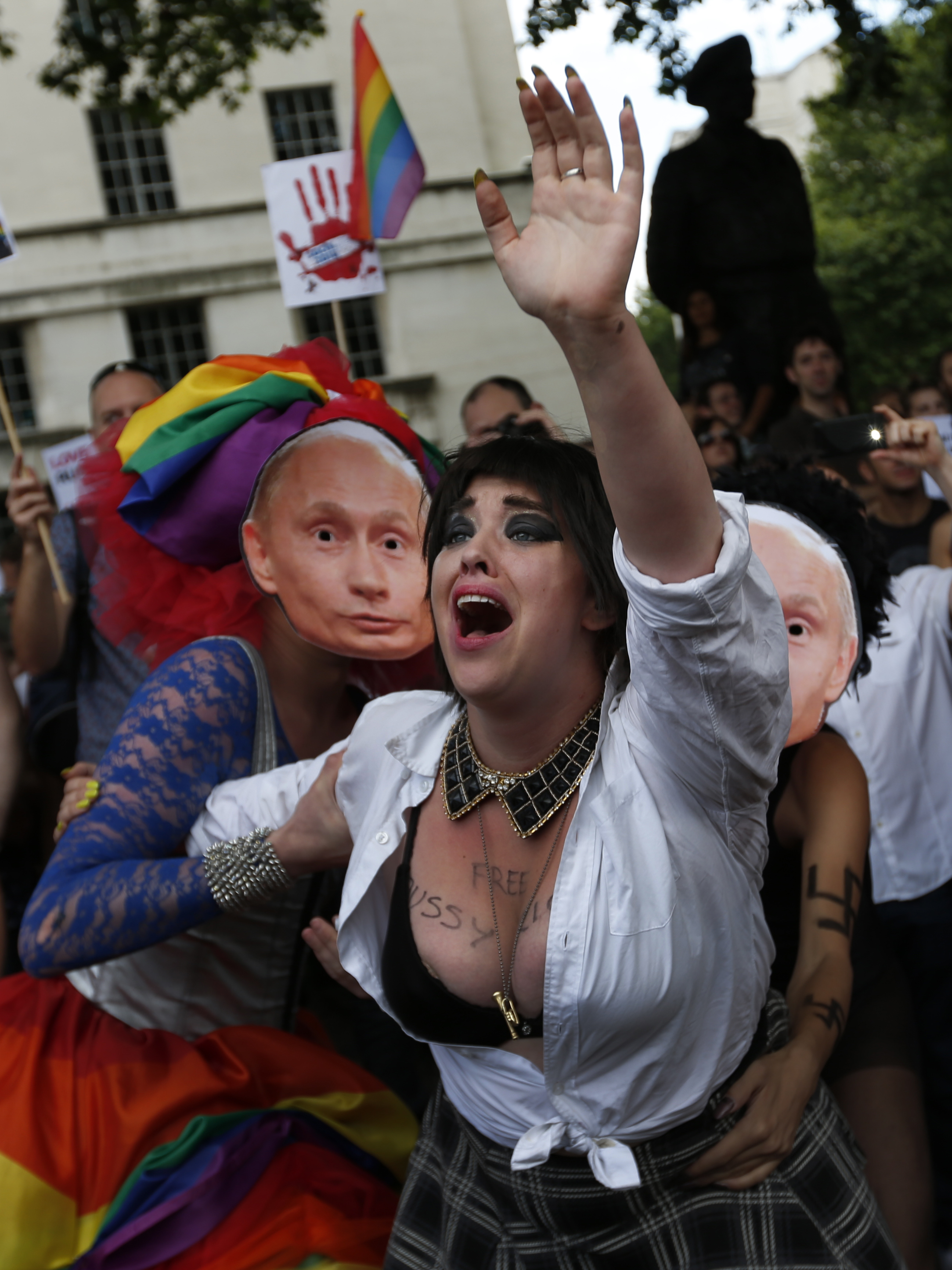 10 August 2013, United Kingdom. During a protest in London, activists stage a performance where LGBT people are apprehended by actors wearing masks of Russian President Vladimir Putin.