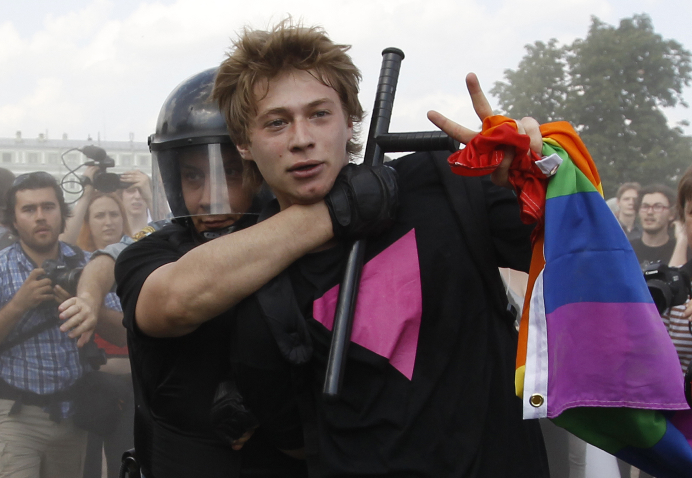 29 June 2013, Russia. A protestor flashes the peace sign during a gay pride event in St. Petersburg that ended when dozens of LGBT rights activists and supporters were attacked. 