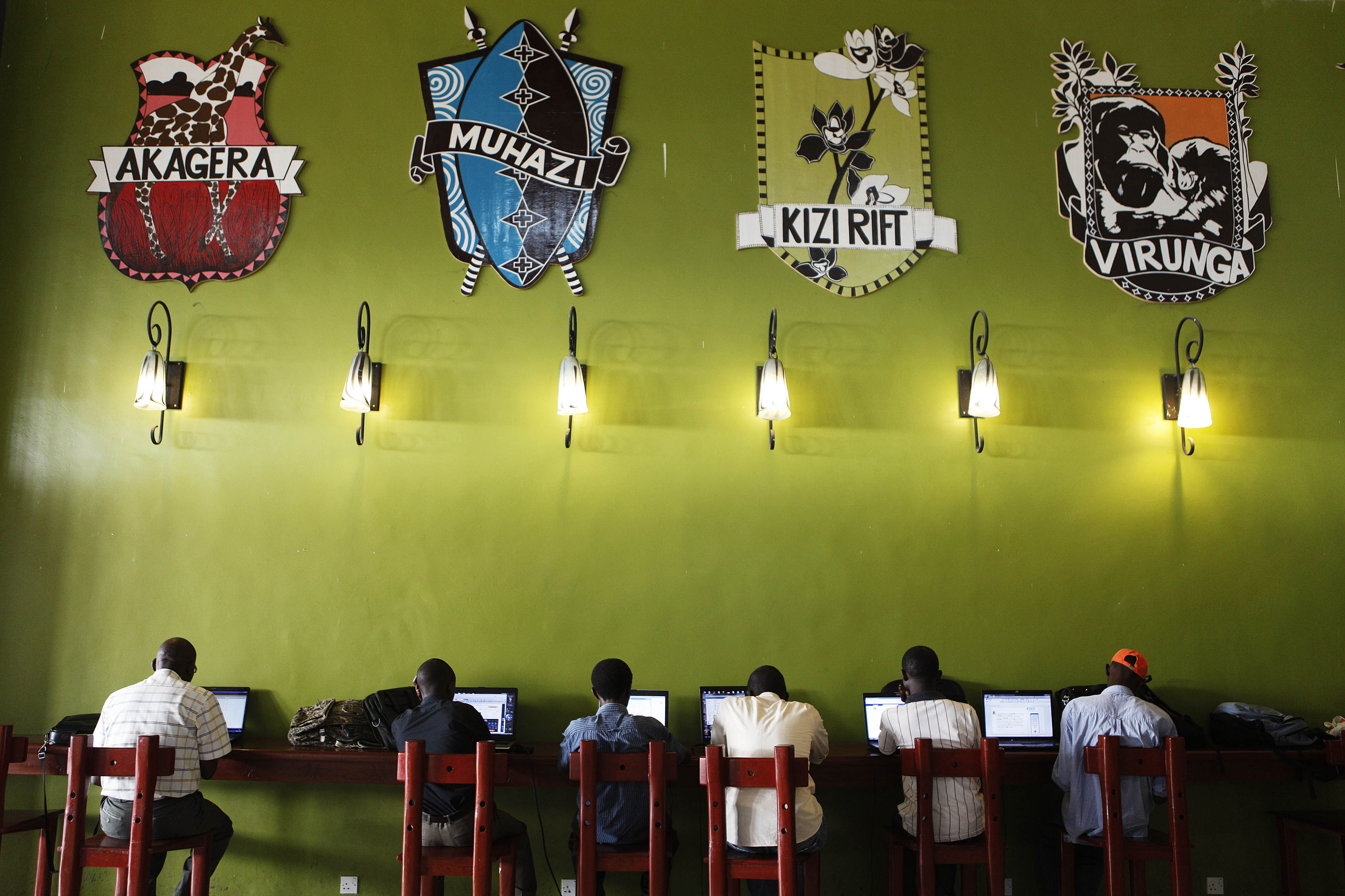 People surf the internet at a free Wi-Fi spot at Kigali international airport as results begin to trickle in from general elections, in the capital Kigali, 9 August 2010
