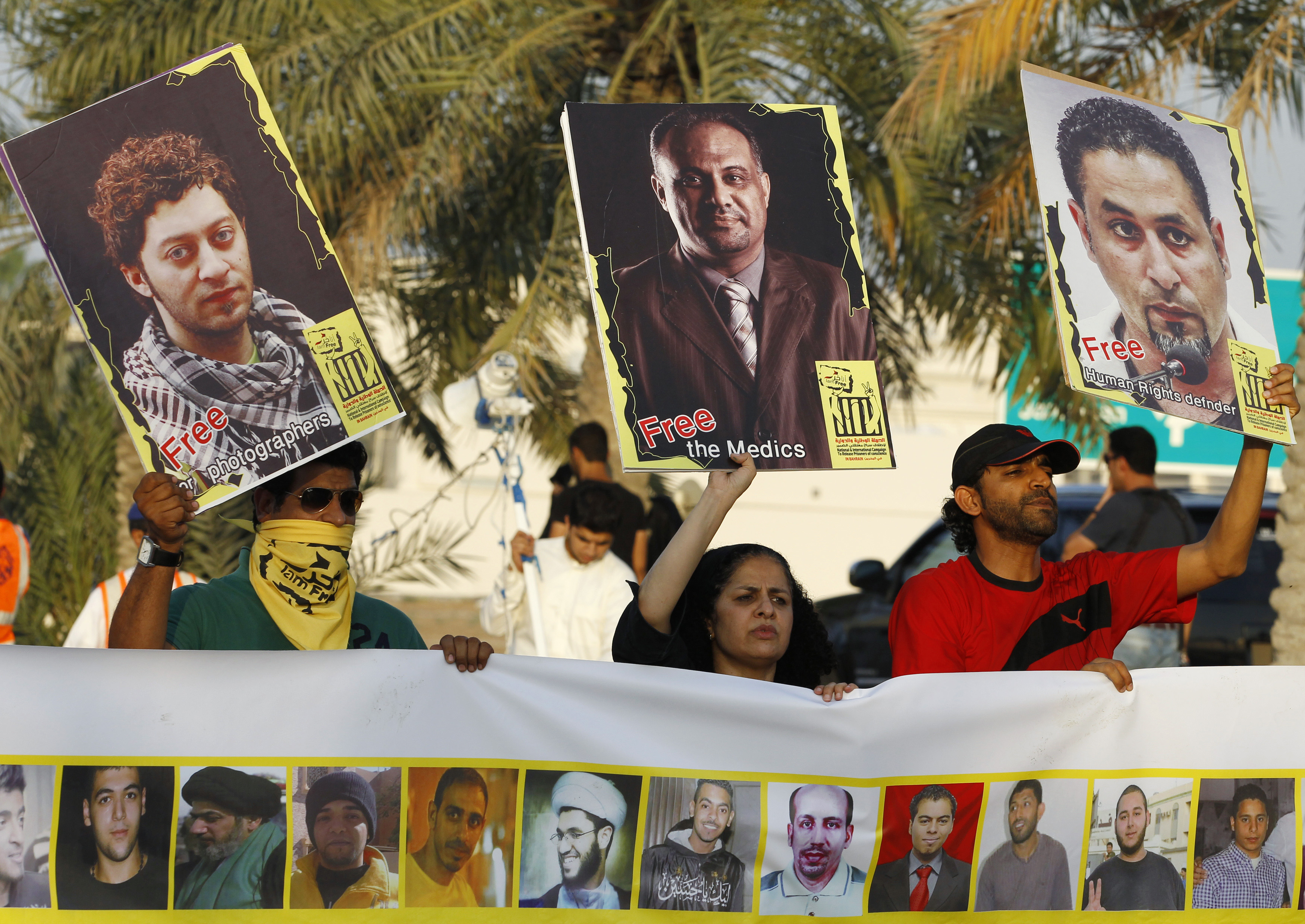 Protesters hold up pictures of journalists, doctors, and activists as they take part in a solidarity march asking for their release, during an anti-government protest organised by Bahrain's main opposition party Al Wefaq in Budaiya, west of Manama, May 9, 2014