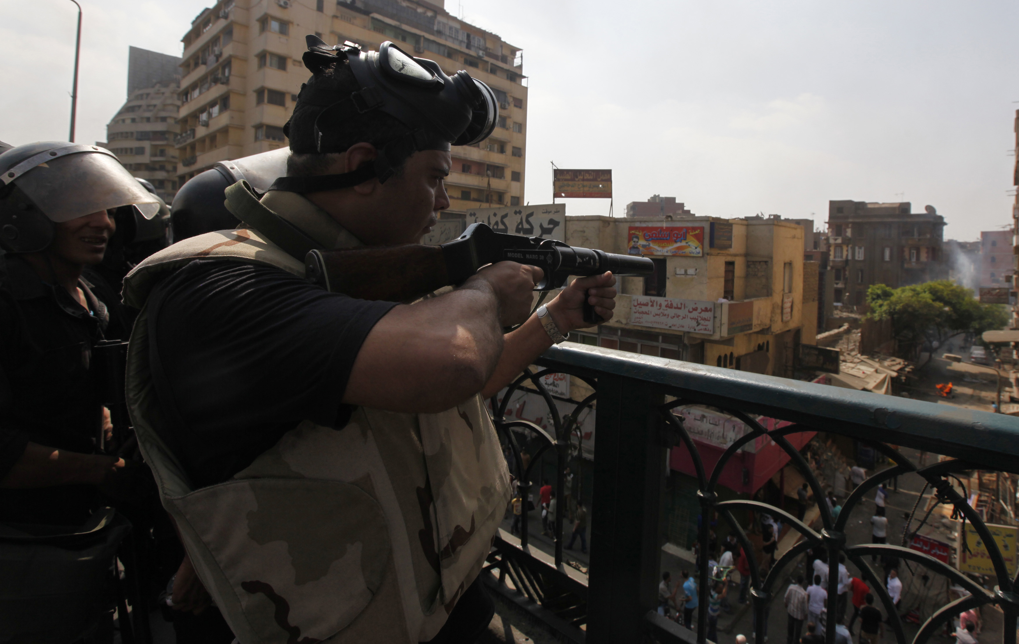 Riot police fire tear gas during clashes with members of the Muslim Brotherhood and supporters of deposed Egyptian President Mohamed Mursi, around Cairo University and Nahda Square on 14 August 2013