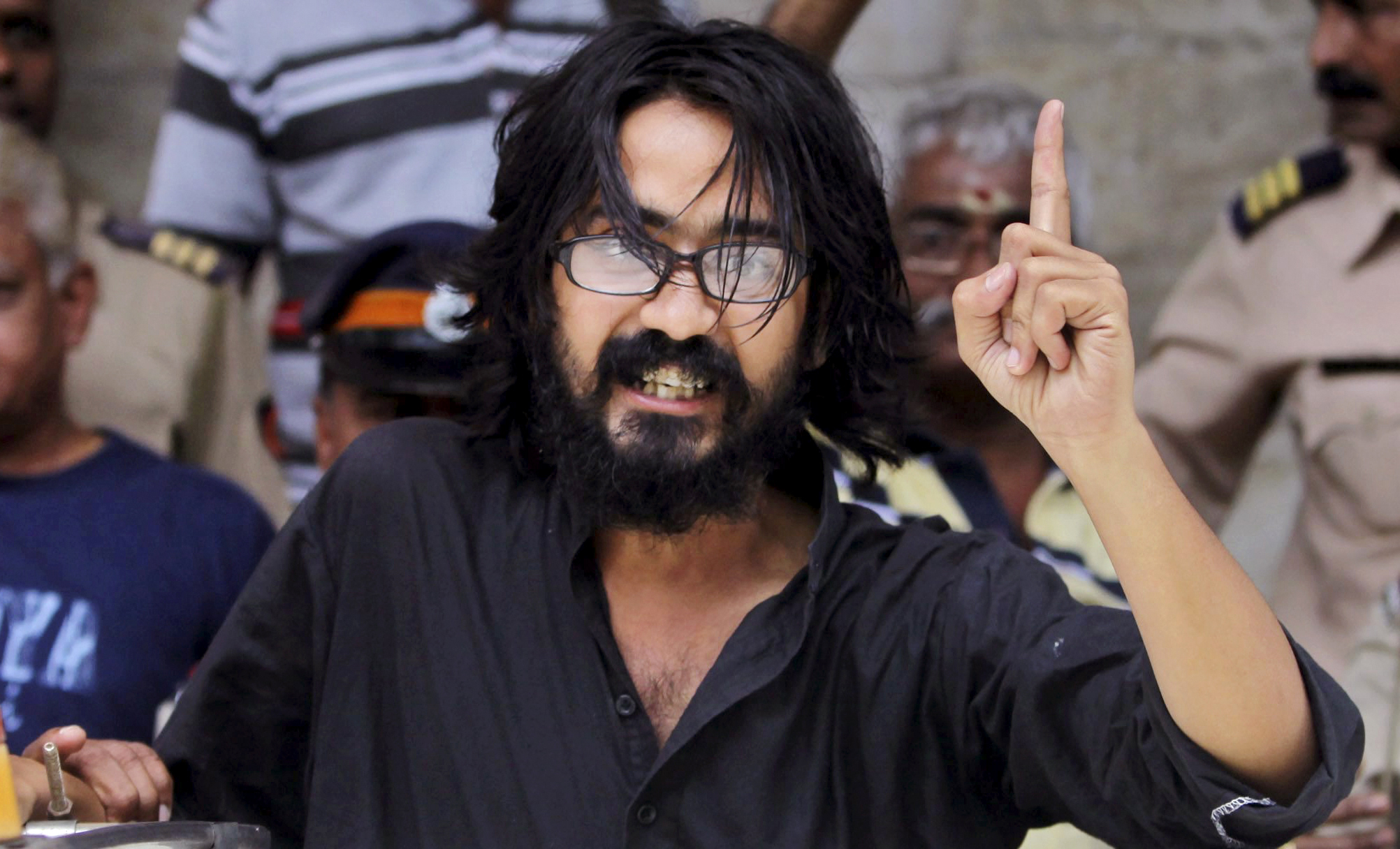 Cartoonist Aseem Trivedi gestures after he is arrested in September 2012 by the police on charges of mocking the Indian constitution in his drawings 