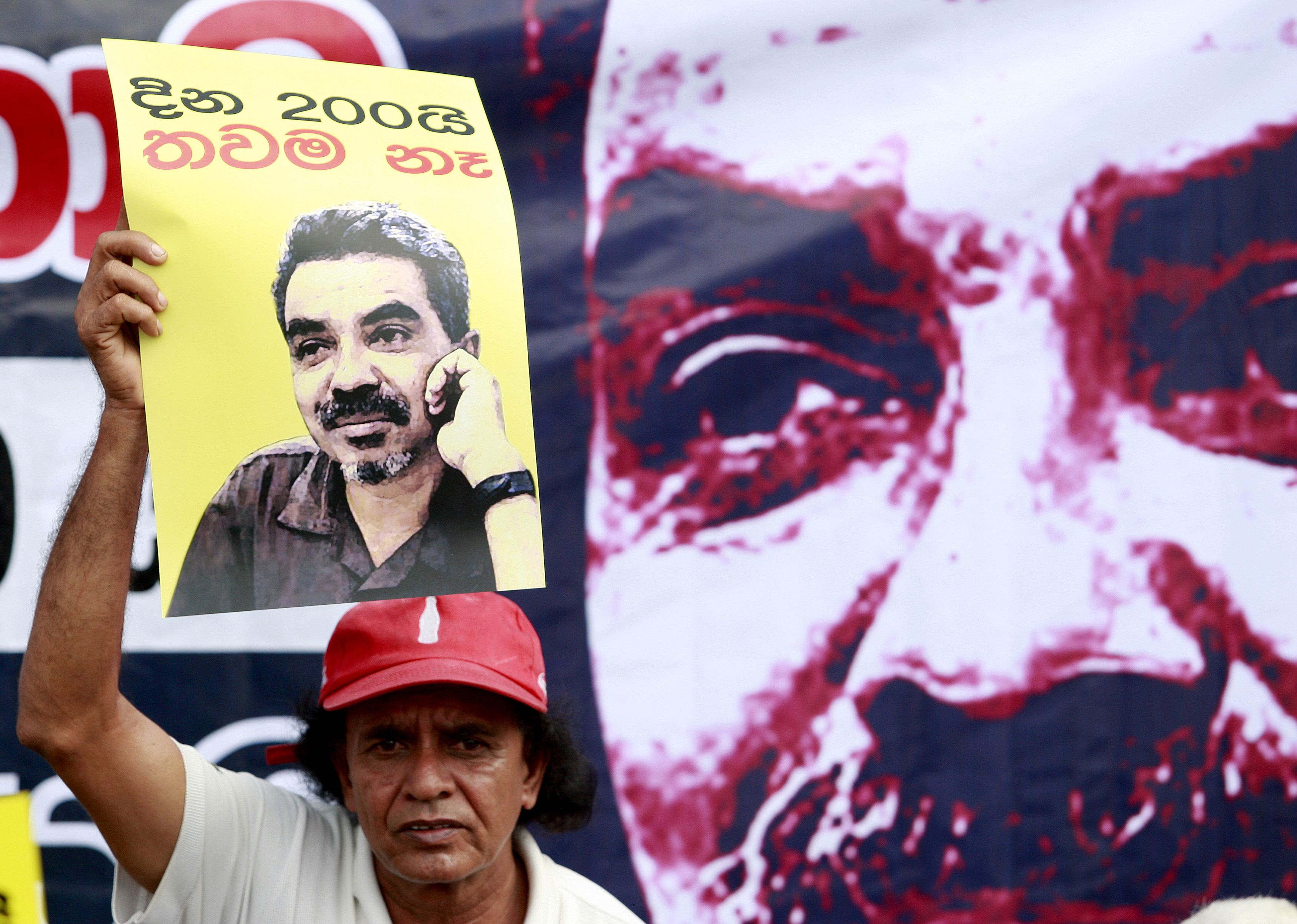 A man holds a placard with an image of missing cartoonist Prageeth Eknaligoda during a protest in Colombo in 2010