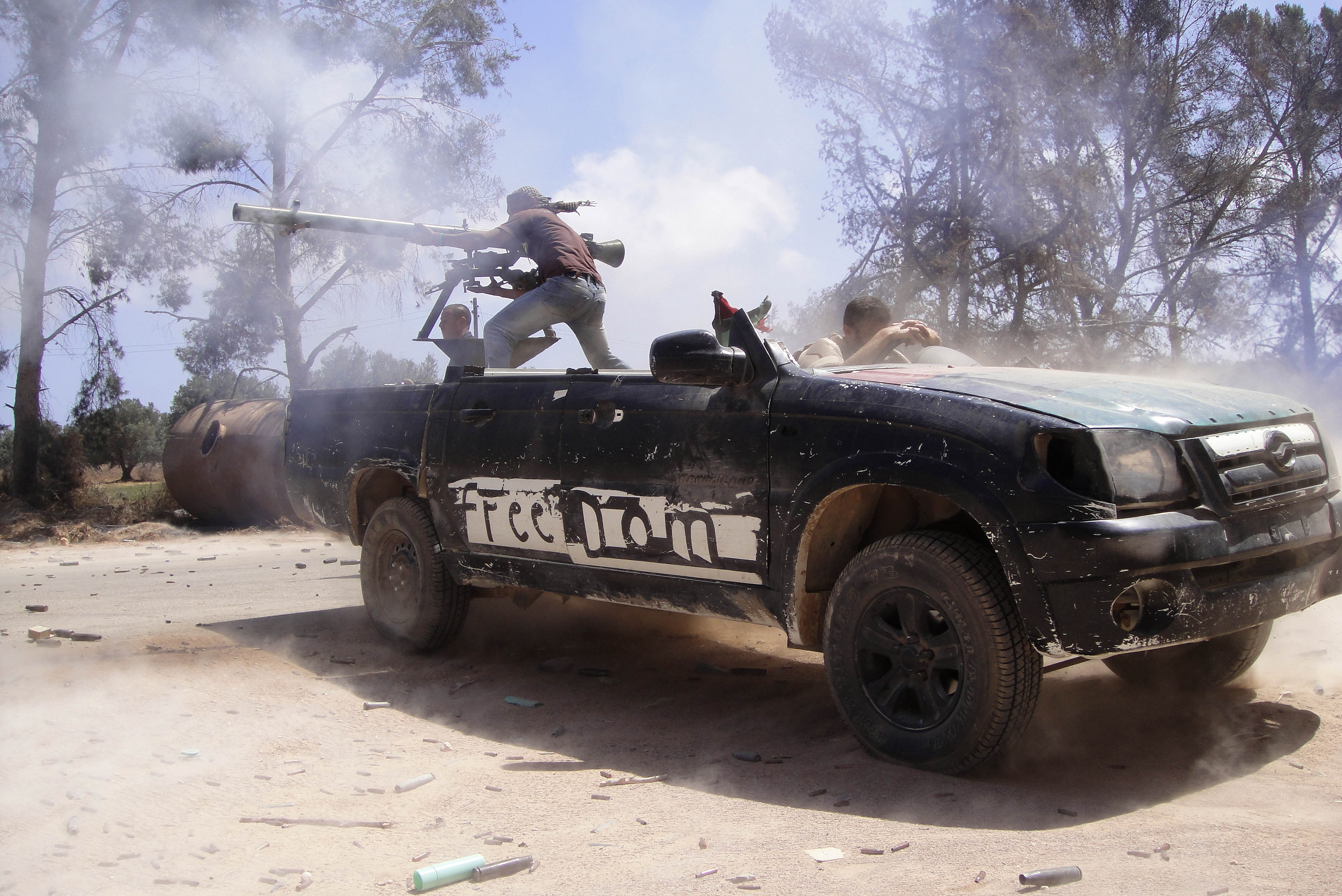 Another 20 June 2011 photo by Fassouk shows rebel fighters firing a rocket toward pro-Qaddafi forces on the front line in Misrata, Libya. 