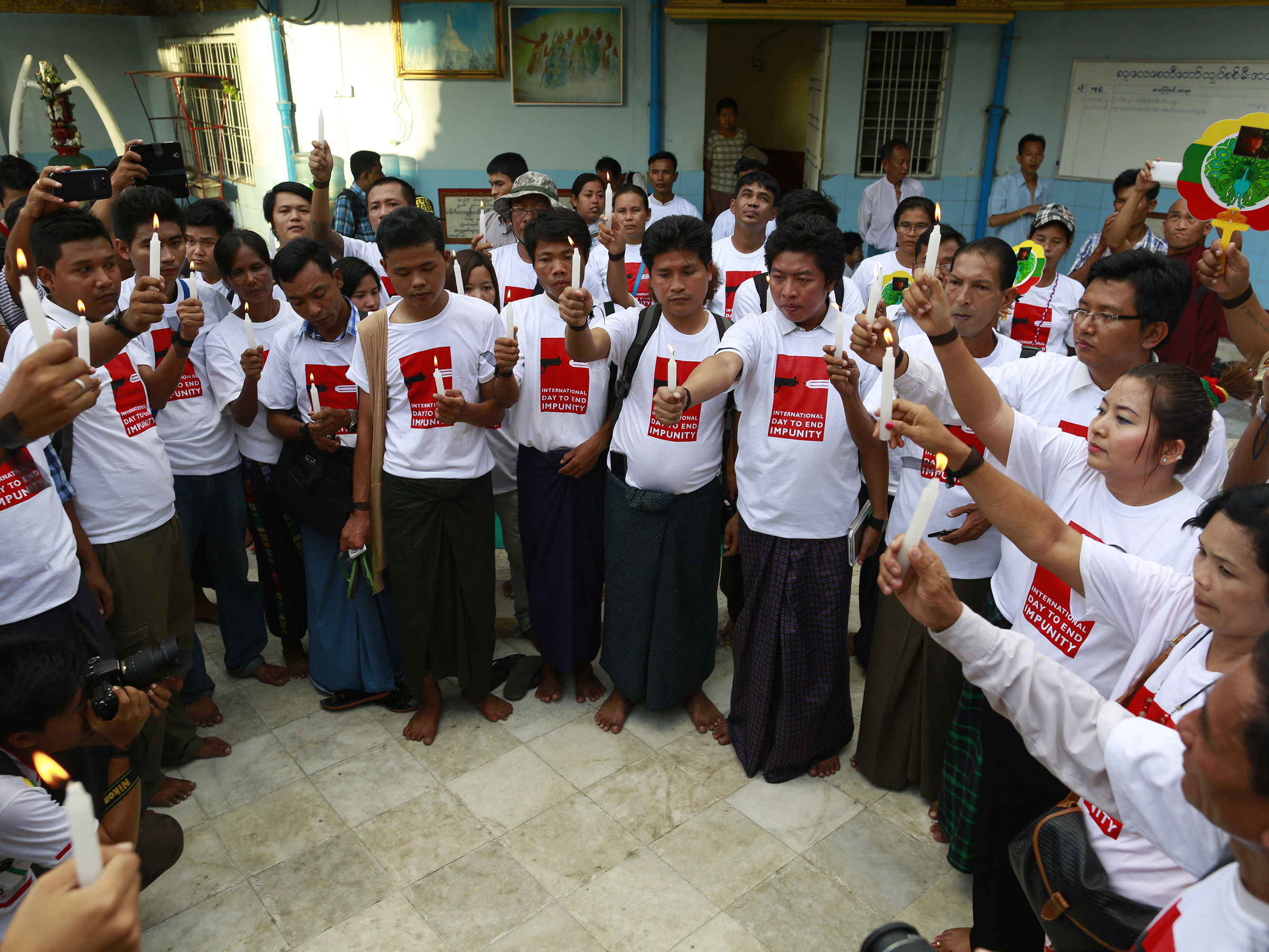 Journalists pray for their colleagues, who were either killed or imprisoned as a result of their work, during a protest to mark the International Day to End Impunity for Crimes against Journalists in Yangon, Myanmar 2 November 2014