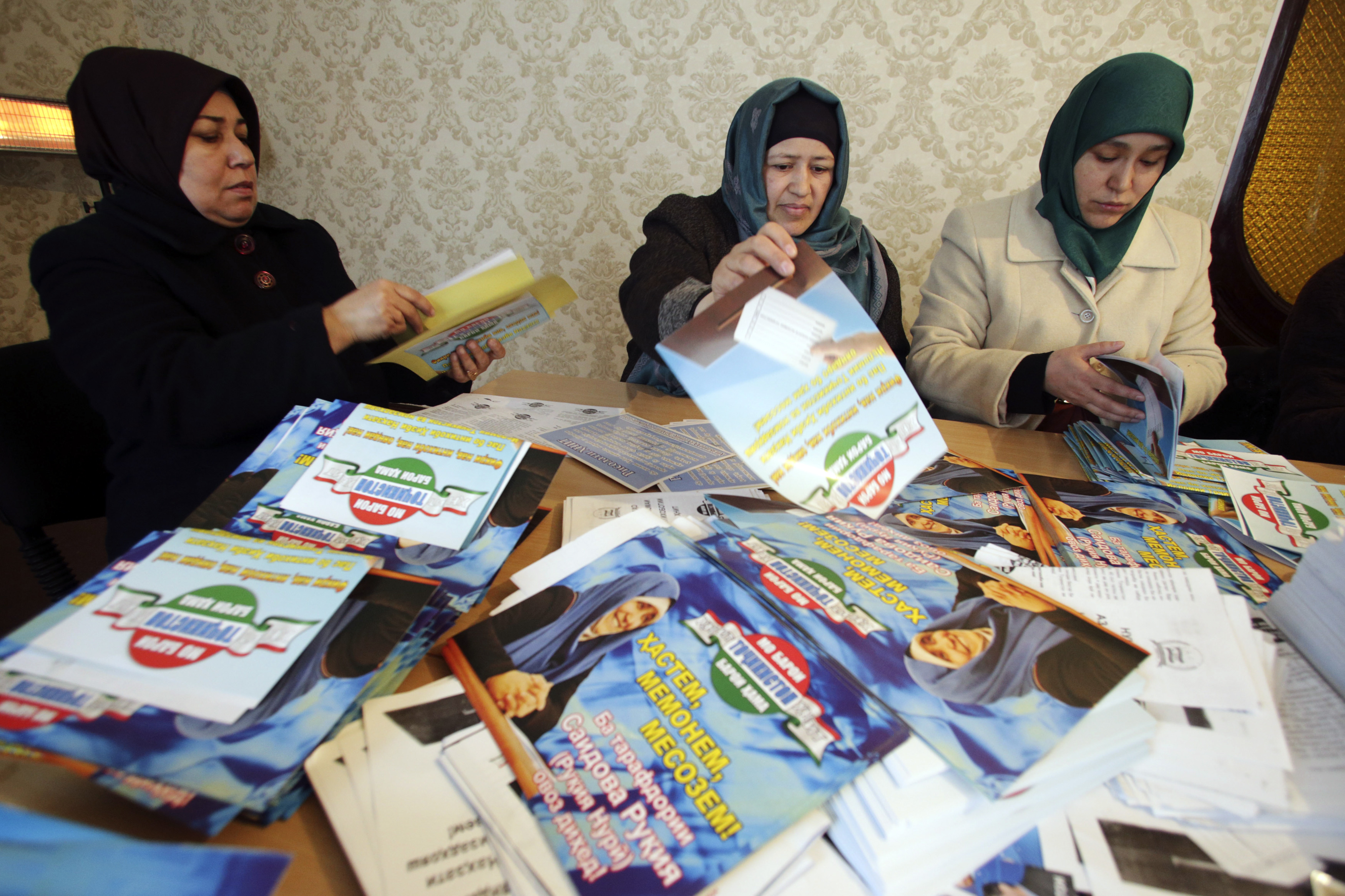 Supporters of the Islamic Renaissance Party of Tajikistan (IRPT) sort pre-election leaflets at the party headquarters in the Tajik capital, Dushanbe, 26 February 2015