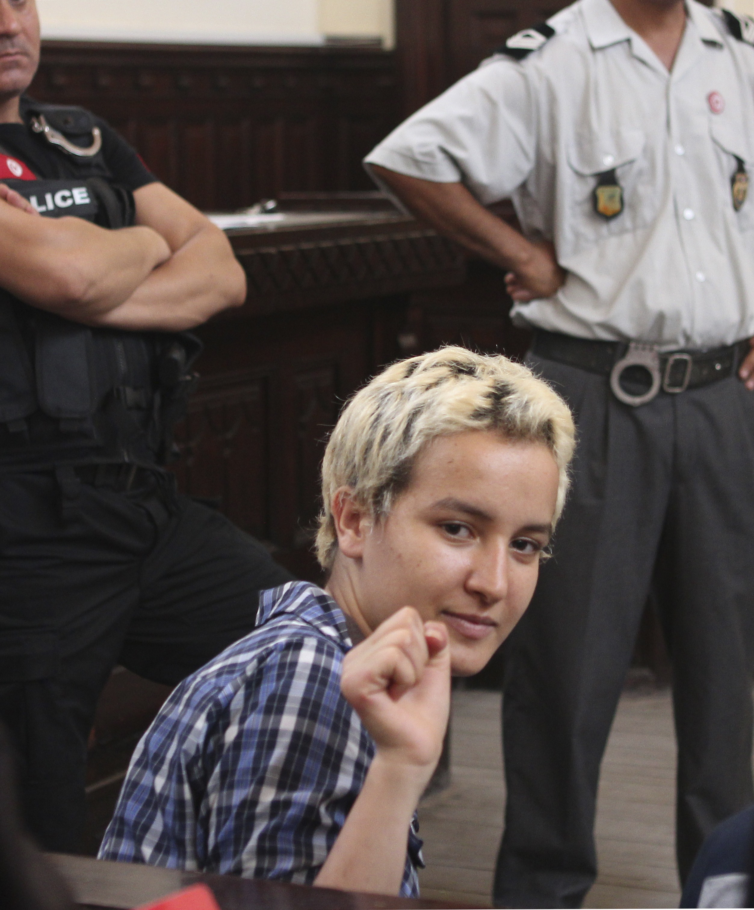 Amina Sboui gestures in a courtroom in Sousse on 4 July 2013