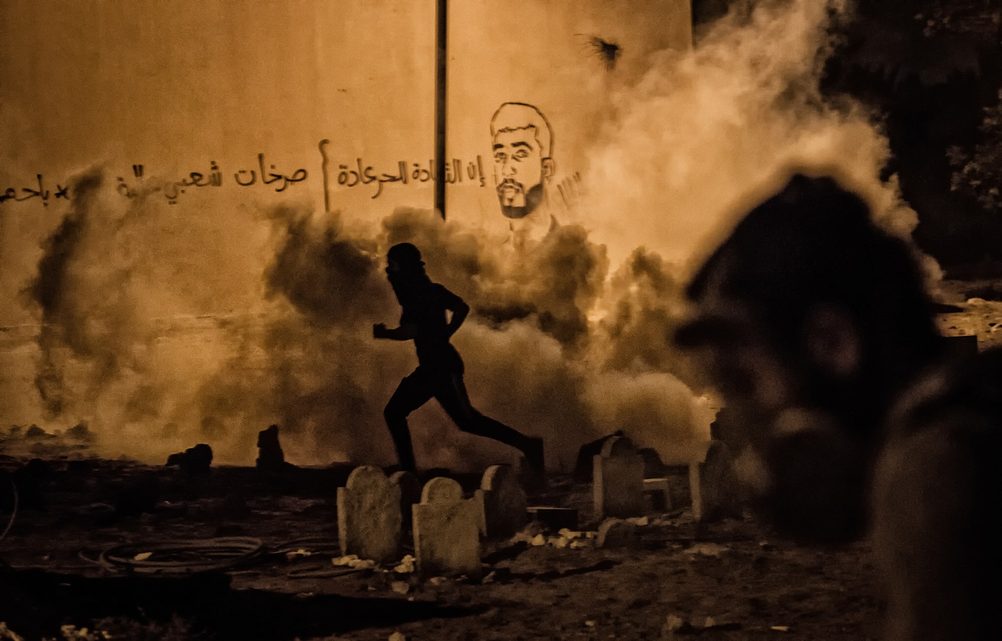 Ahmed AlFardan's photo of a protester running from tear gas shot by police in Bahrain got second place in IFEX's Impunity Exposed photo contest, Ahmed AlFardan