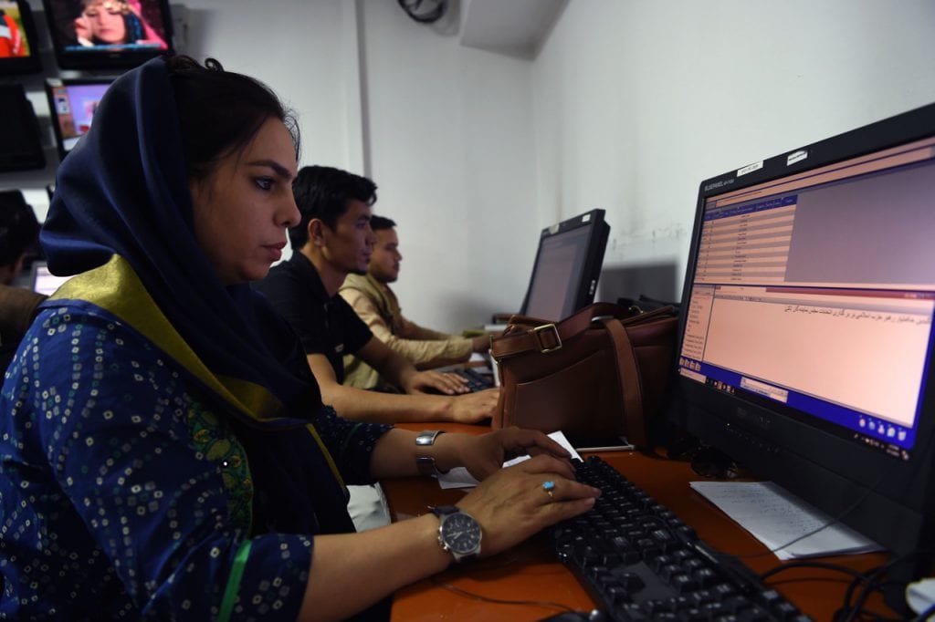 Tolo News reporters work in the newsroom at Tolo TV station in Kabul, Afghanistan, 11 September 2018, WAKIL KOHSAR/AFP/Getty Images