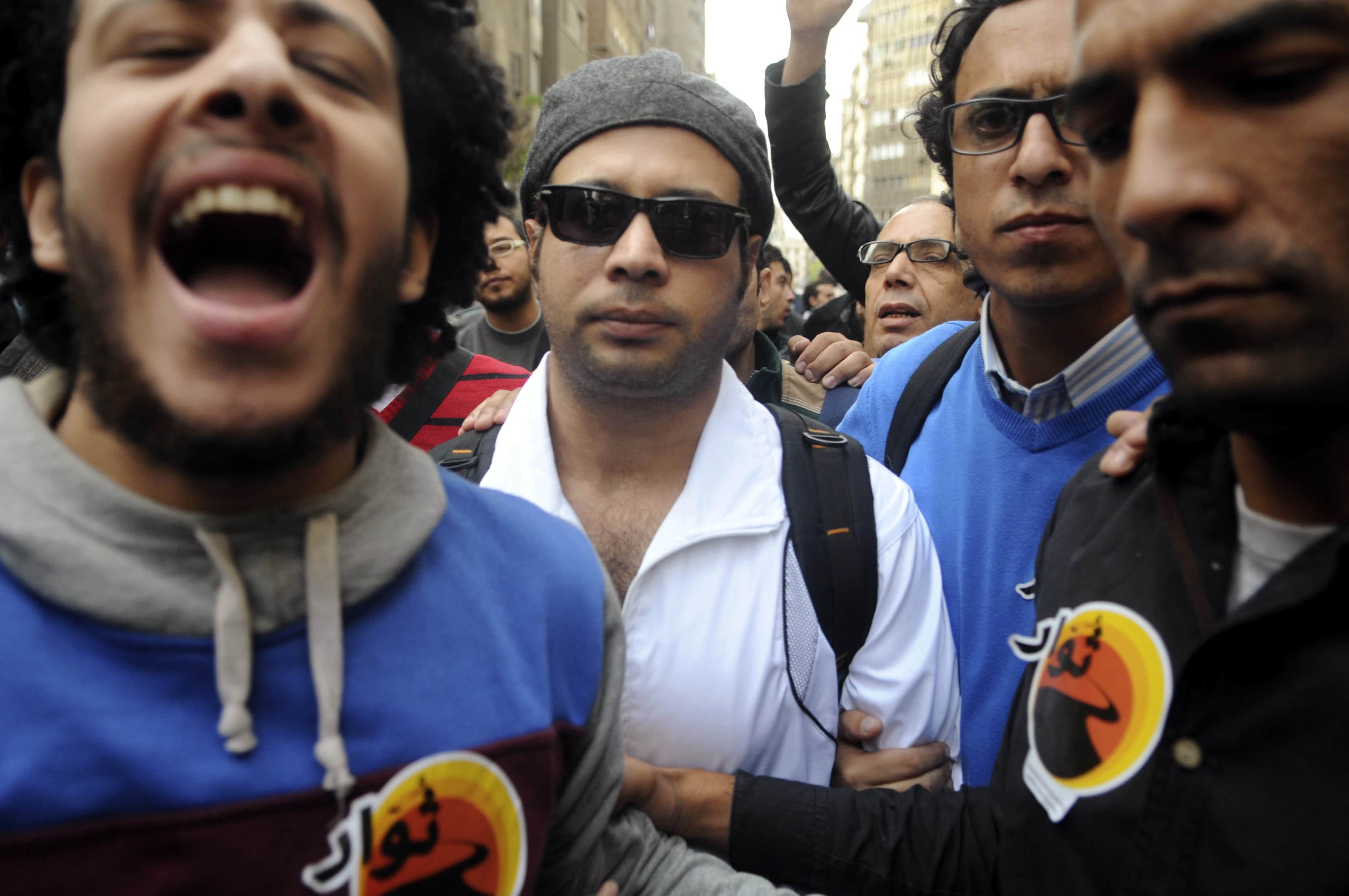 Ahmed Maher (C), founder of the April 6 movement, turns himself in at Abdeen court in Cairo on 30 November 2013, REUTERS/Stringer