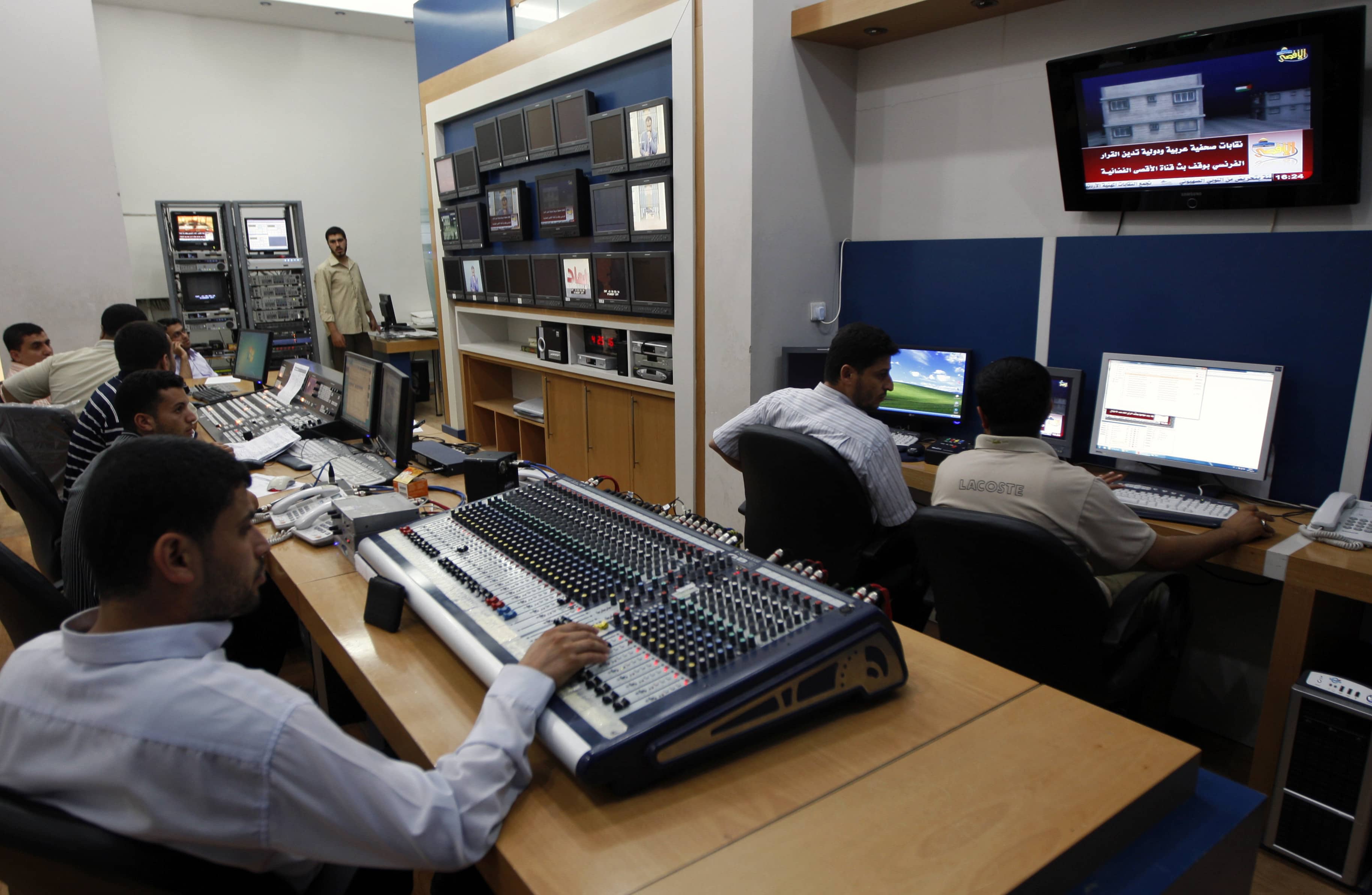 Palestinian crew work in the control unit at the Al Aqsa T.V. station in Gaza City (June 2010), AP Photo/Khalil Hamra