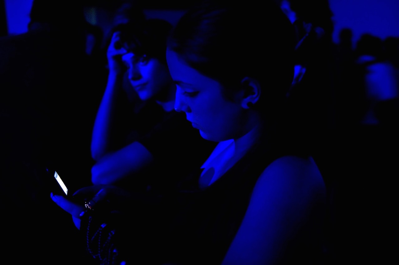 A woman uses her cell phone during a 25 May 2010 concert in Caracas, Venezuela, MIGUEL GUTIERREZ/AFP/Getty Images