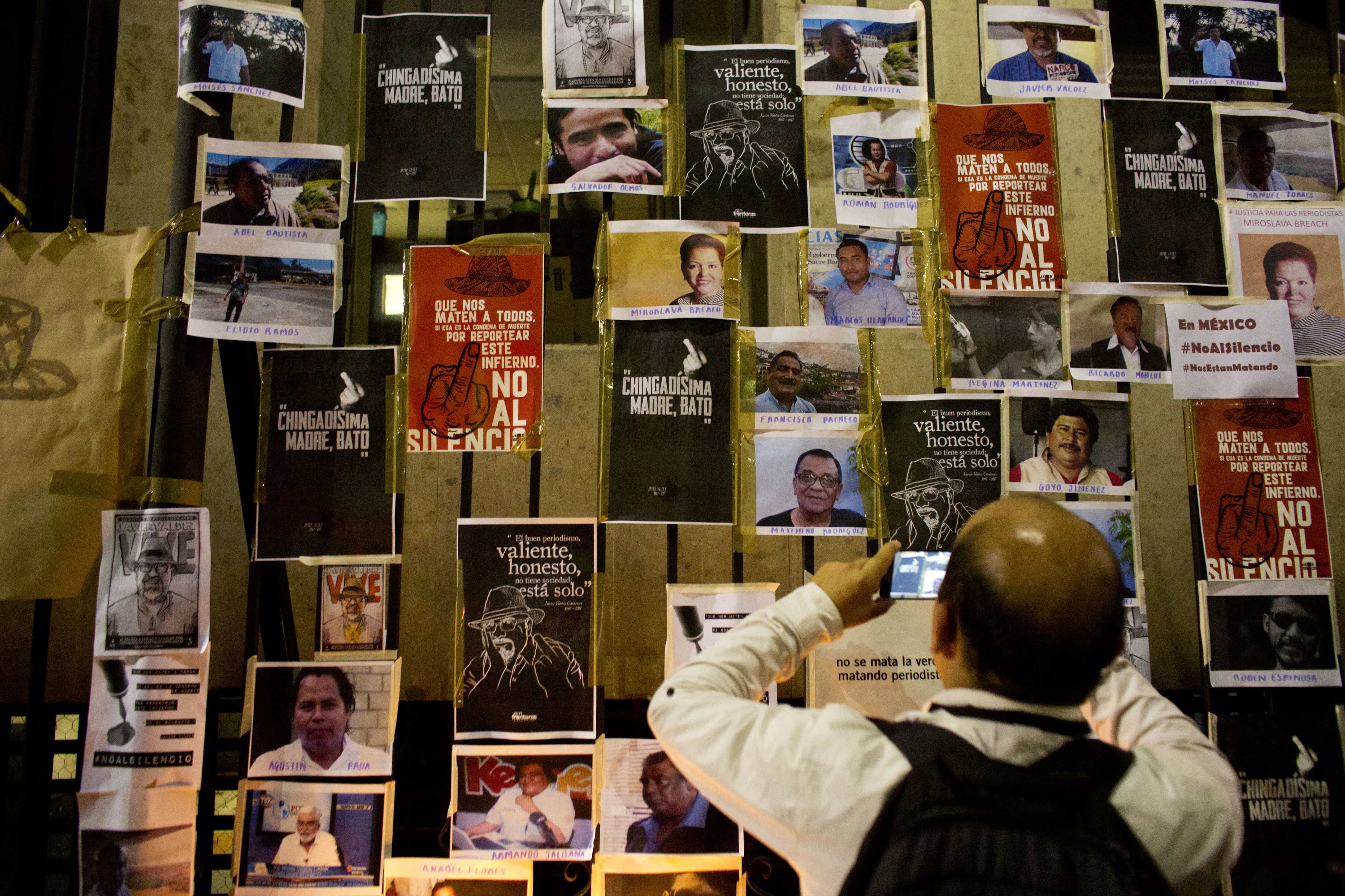 Photos of slain Mexican journalists placed around the Interior Minister's Office, Associated Press