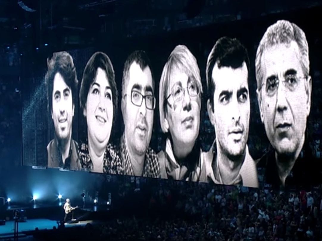Photos of Azerbaijani human rights defenders and journalists are projected at a U2 concert in Montréal, Canada, June 2015 , Sport for Rights/U2/YouTube/Meydan TV