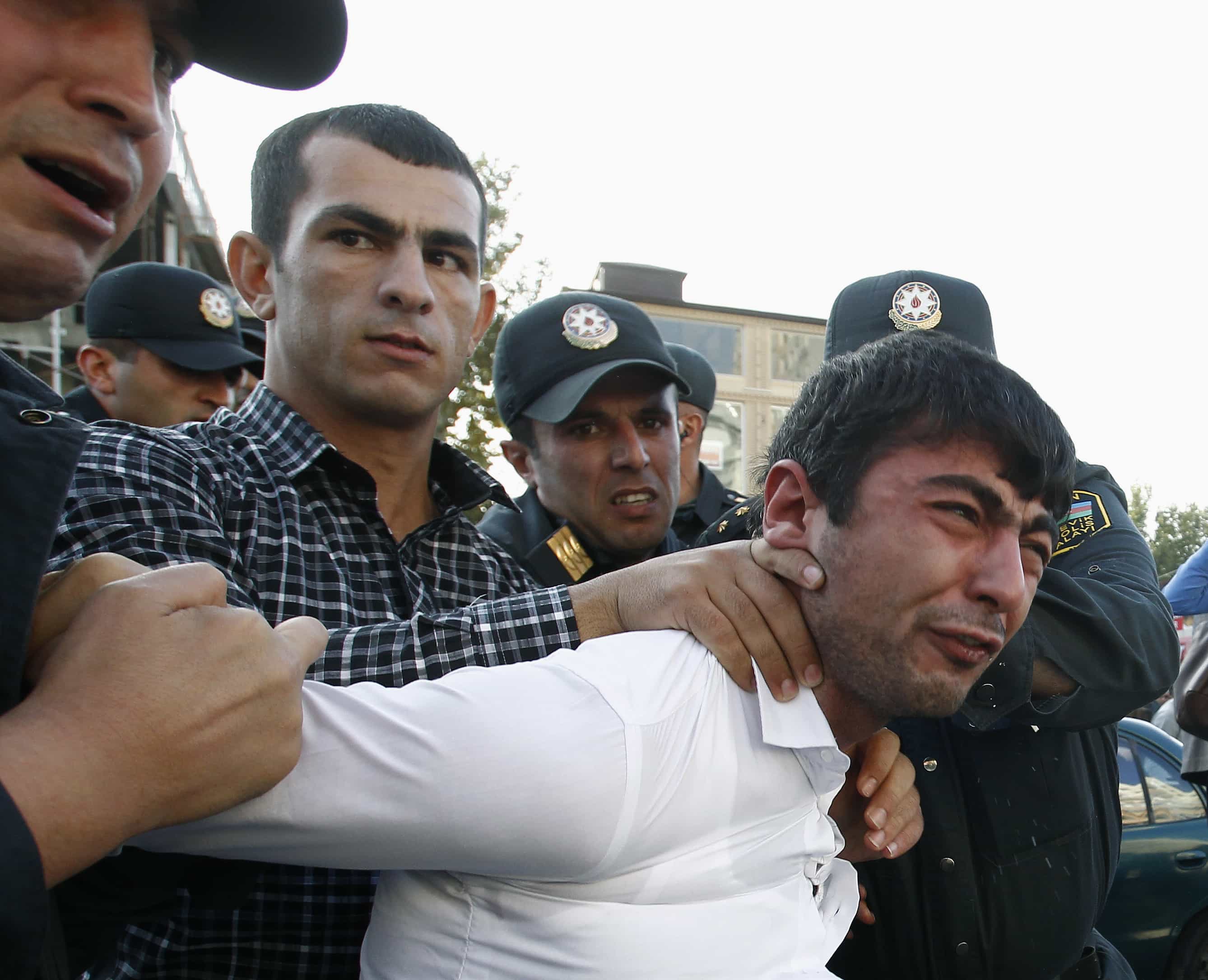 Police detain an opposition supporter in Baku, 12 October 2013, REUTERS/David Mdzinarishvili