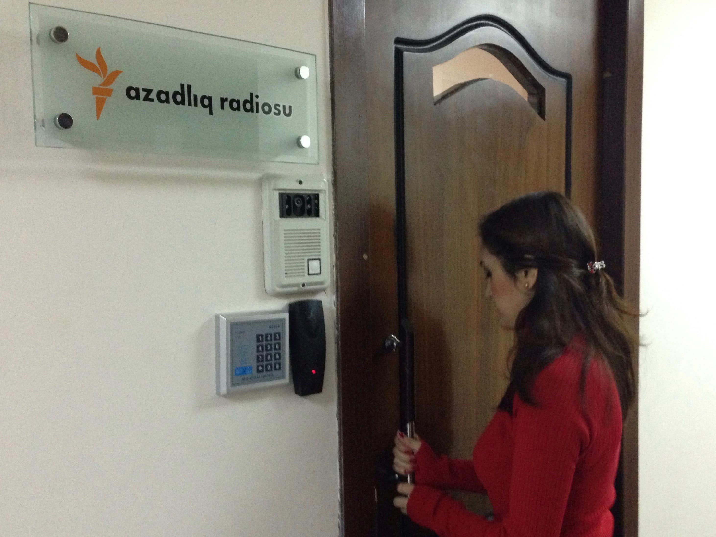 A journalist enters Radio Free Europe headquarters in Baku, 26 December 2014, AP Photo/Aziz Karimov