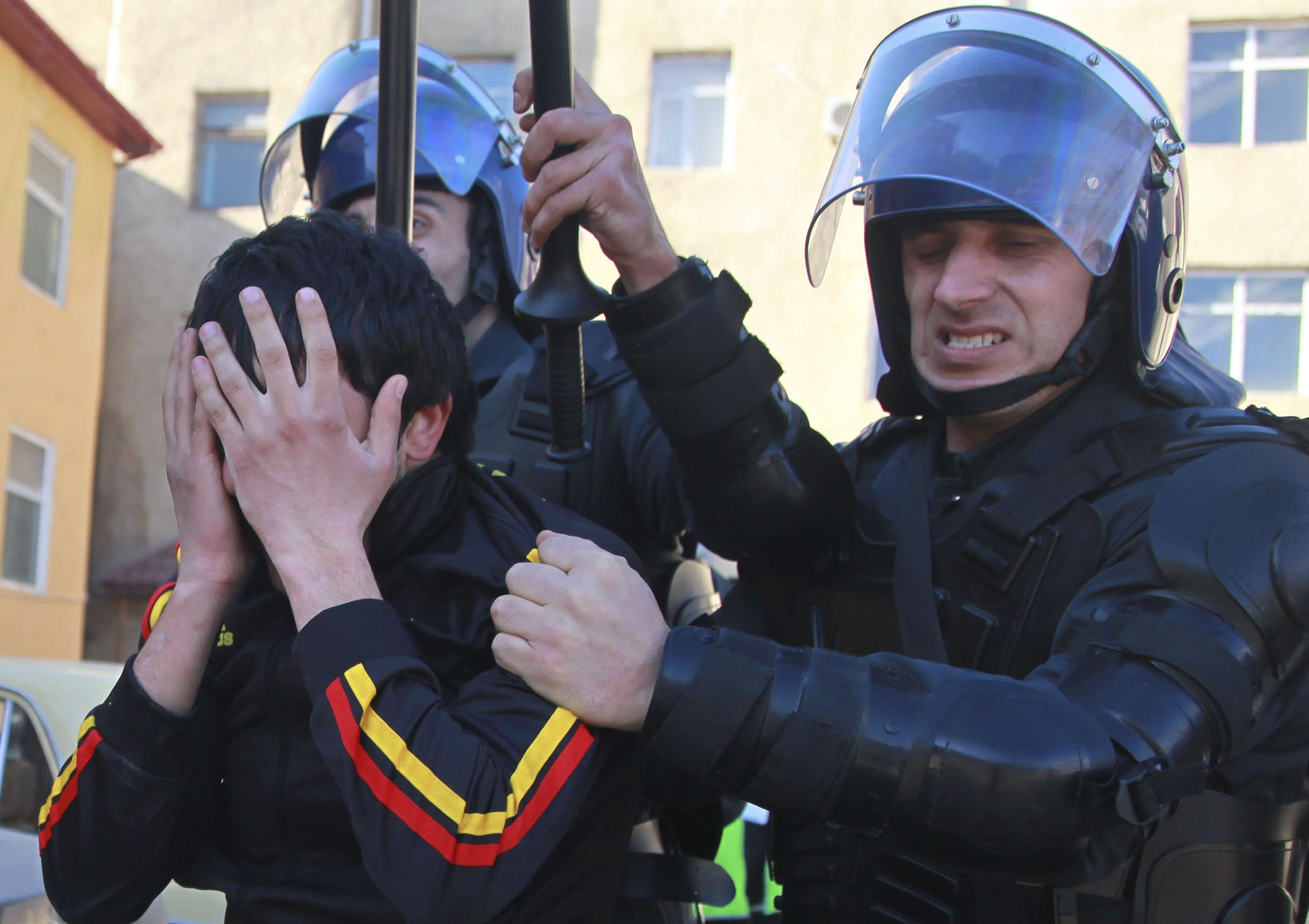 Azerbaijani police officers detain a demonstrator in Ismayilli, 24 January 2013. , AP Photo/Aziz Karimov