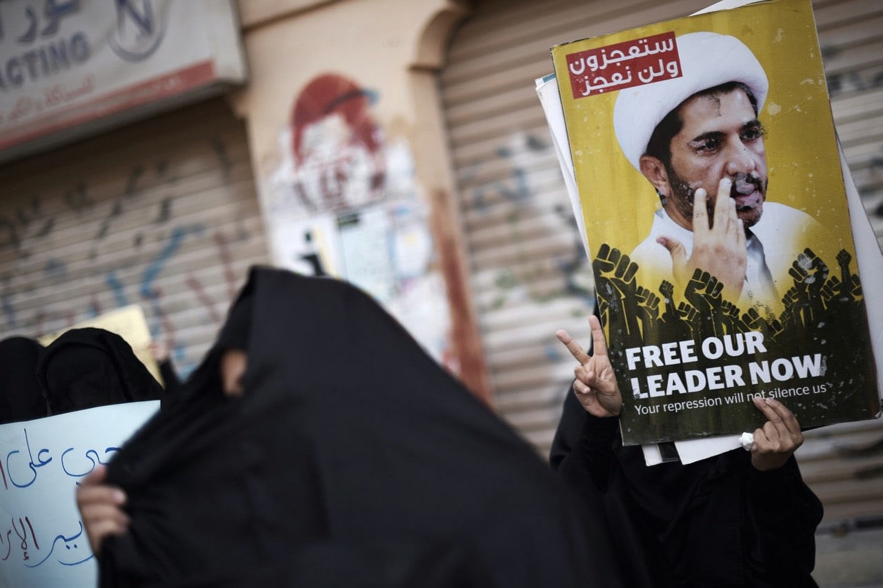 Bahraini protestors hold placards depicting portraits of Sheikh Ali Salman, head of the Al-Wefaq opposition movement, to protest his arrest, in the village of Sitra, south of the capital Manama, 29 January 2016, MOHAMMED AL-SHAIKH/AFP/Getty Images