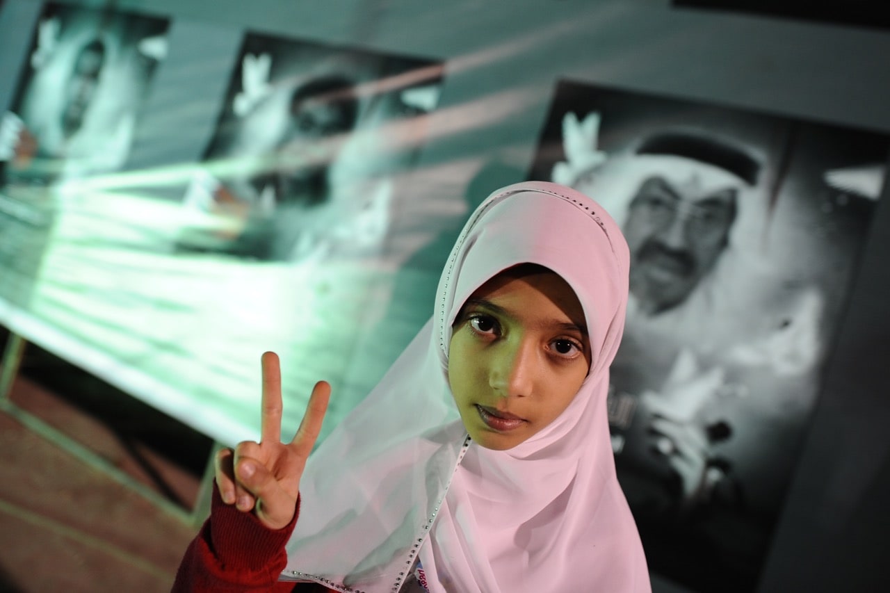 A Bahraini Shiite girl flashes a victory sign during an anti-government rally in the village of Muqsha, west of Manama, 24 December 2011,  -/AFP/Getty Images