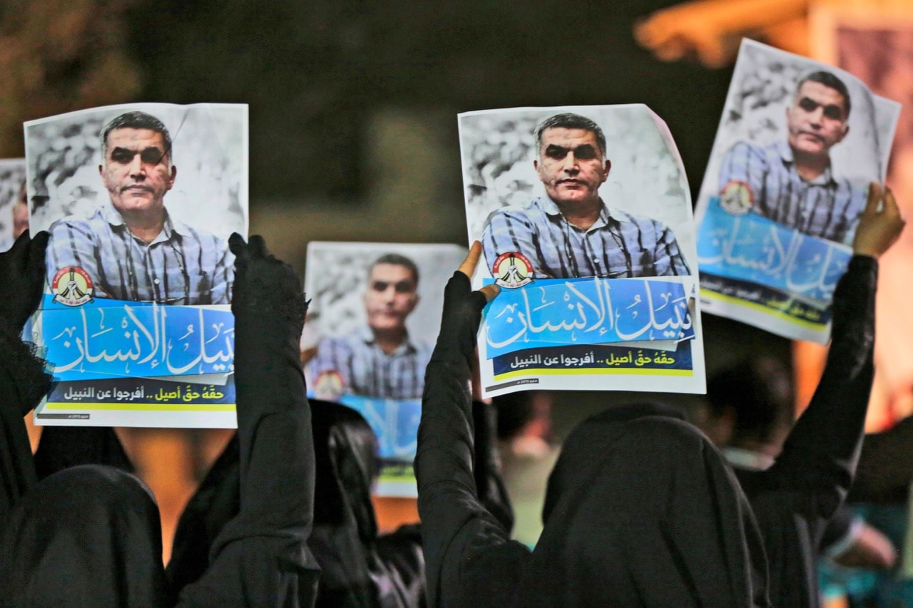 Anti-government protesters hold up images of jailed human rights activist Nabeel Rajab during a solidarity protest outside his home in Bani Jamra, Bahrain, 14 May 2015, AP Photo/Hasan Jamali, File