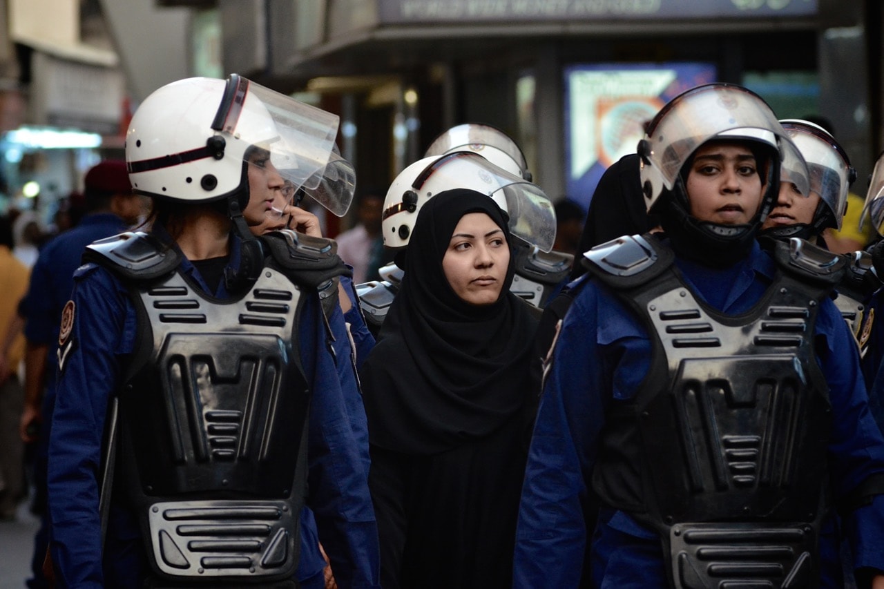Bahraini riot policewomen detain a protester during an anti-government demonstration in central Manama, 13 June 2012, MOHAMMED AL-SHAIKH/AFP/GettyImages