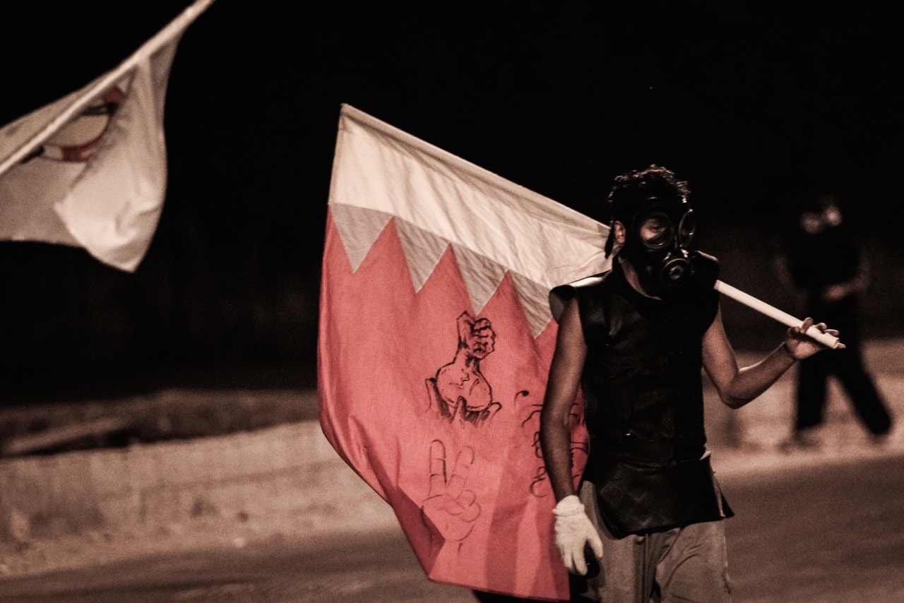 A youth wears a mask to protect himself against the tear gas fired by police during an anti-government protest in Abu Saiba village, west of the capital Manama, Bahrain, 4 July 2014, NurPhoto/Corbis via Getty Images