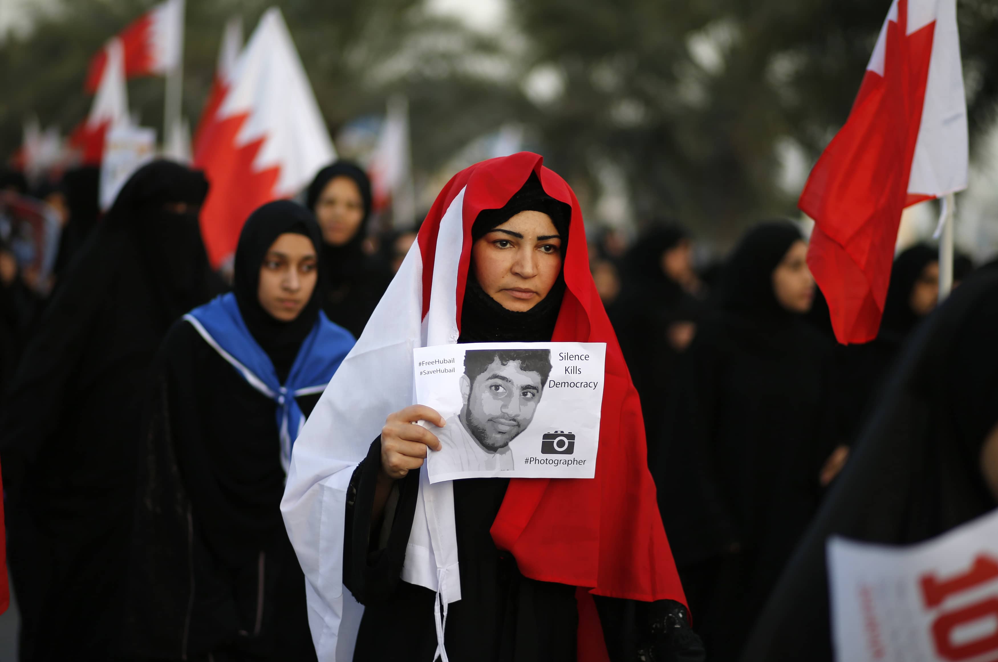 A protester holds a poster of detained photographer Hussein Hubail during an anti-government rally in Budaiya, west of Manama on 13 December 2013, REUTERS/Hamad I Mohammed