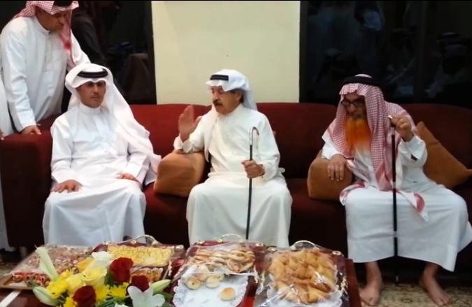 Photo taken from video in which the prime minister (C) thanks Mubarak Bin Huwail (L) for his services to Bahrain, YouTube