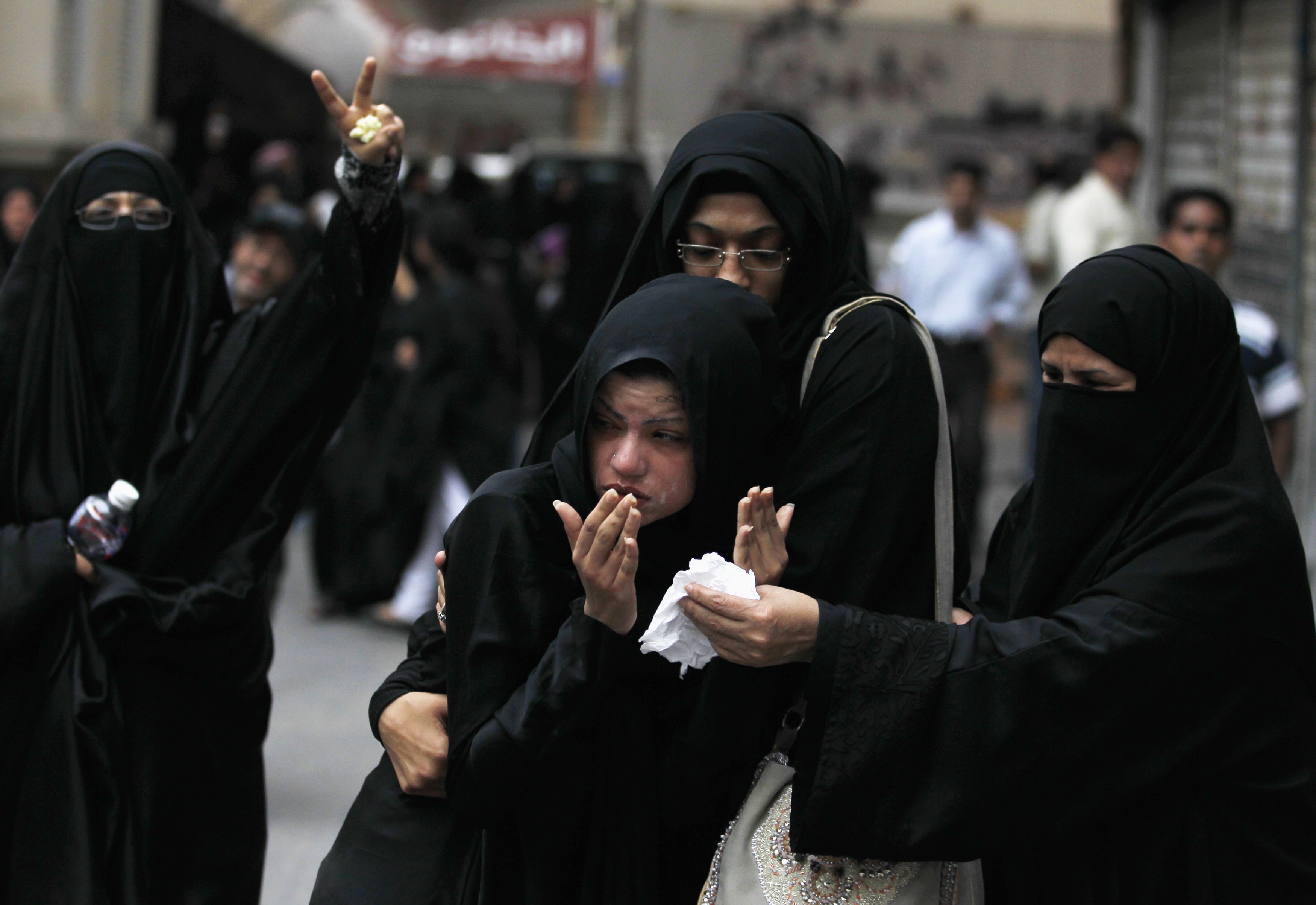 An anti-government protester (C) is carried by her fellow protesters after she was pepper-sprayed by riot police during a rally in Manama on 7 April 2012, REUTERS/Hamad I Mohammed
