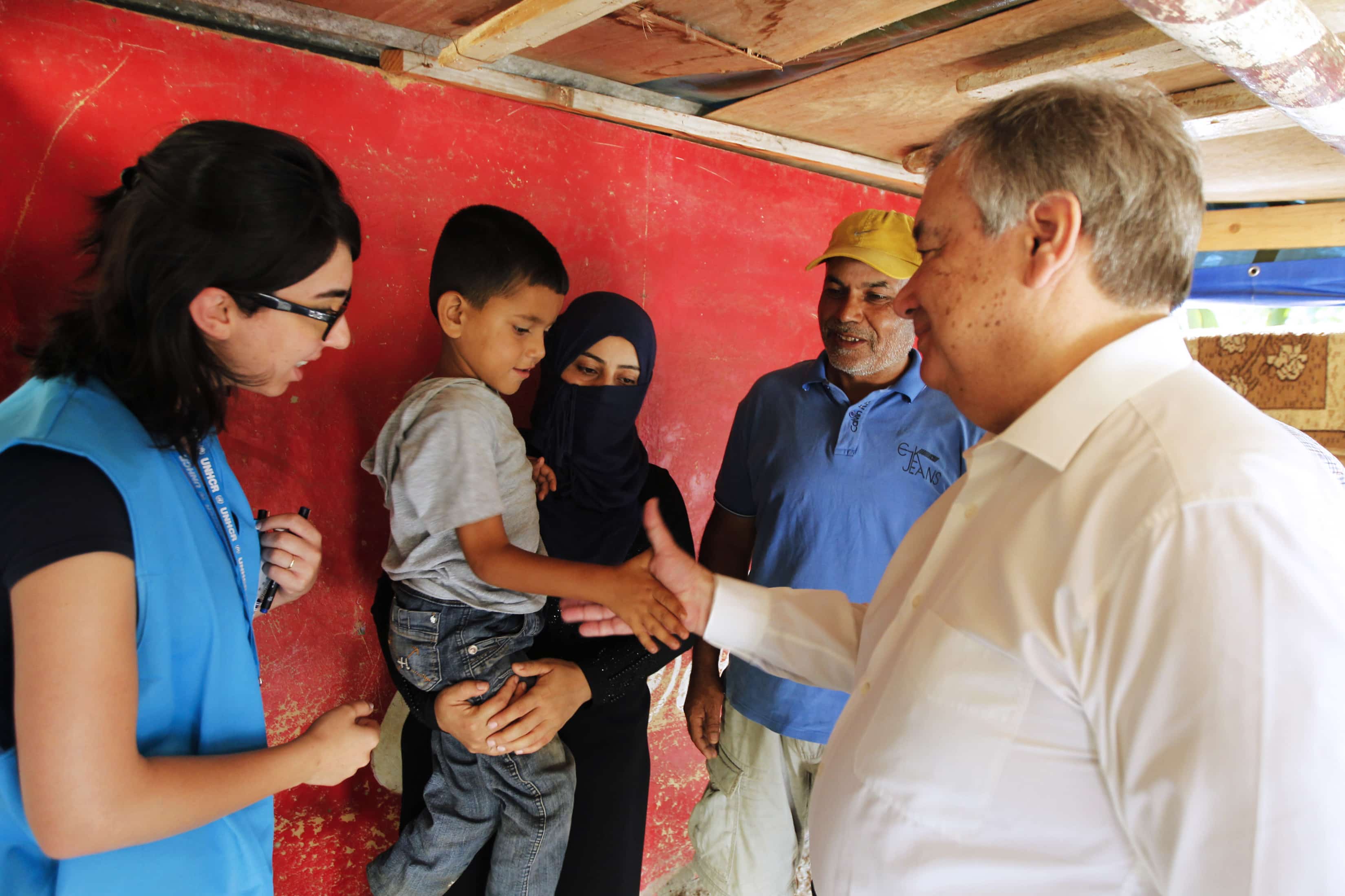 United Nations High Commissioner for Refugees Antonio Guterres (R) interacts with a child as he visits a Syrian refugee family in Beirut June 19, 2014, REUTERS/Mohamed Azakir