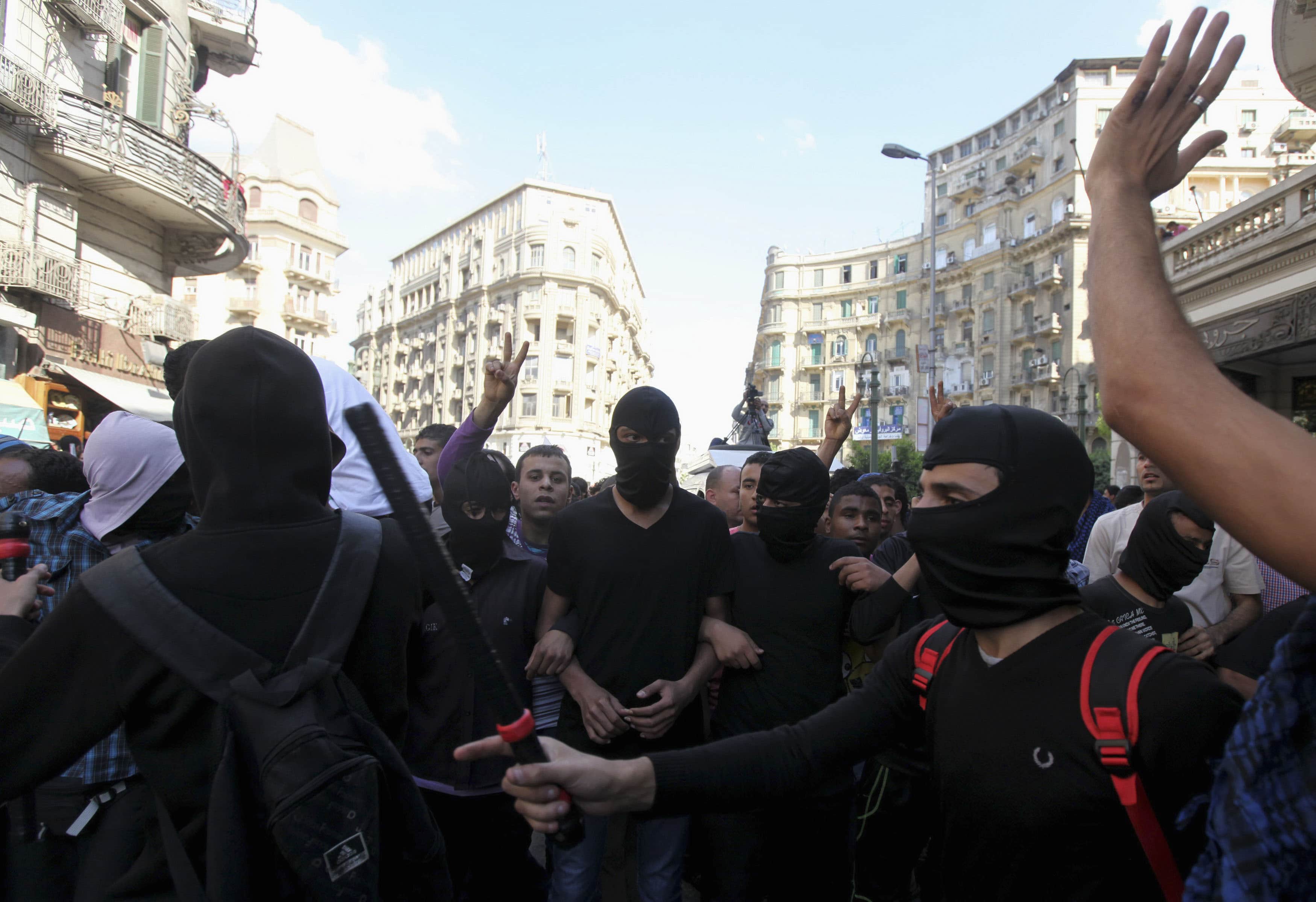 Protesters claiming to be members of the 'Black Bloc' prepare to clash with demonstrators loyal to the Muslim Brotherhood in an area near Tahrir Square on 19 April 2013, REUTERS/Mohamed Abd El Ghany
