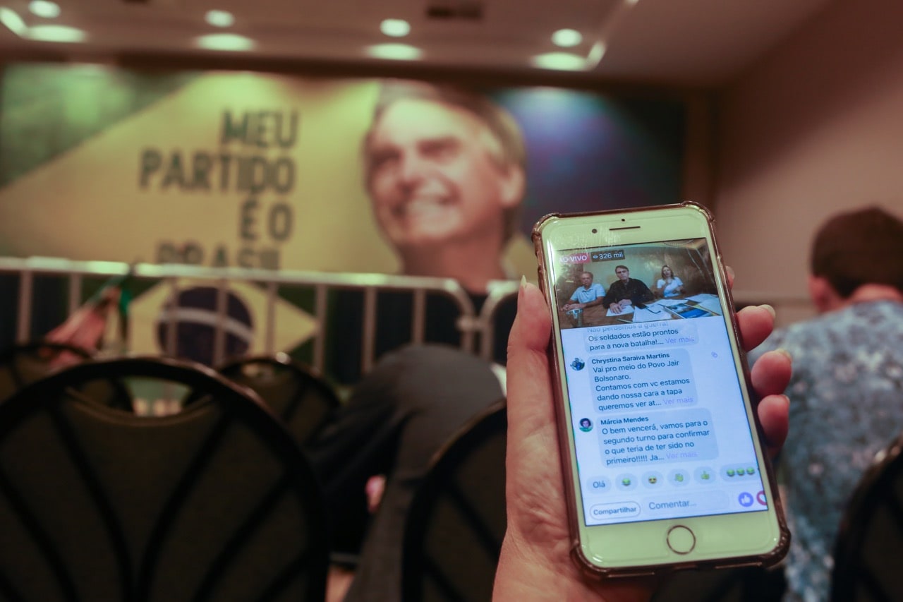 Journalists at a hotel watch Jair Bolsonaro speak live about the results of the first round of the election, in Rio de Janeiro, Brazil, 7 October 2018, Ian Cheibub/picture alliance via Getty Images