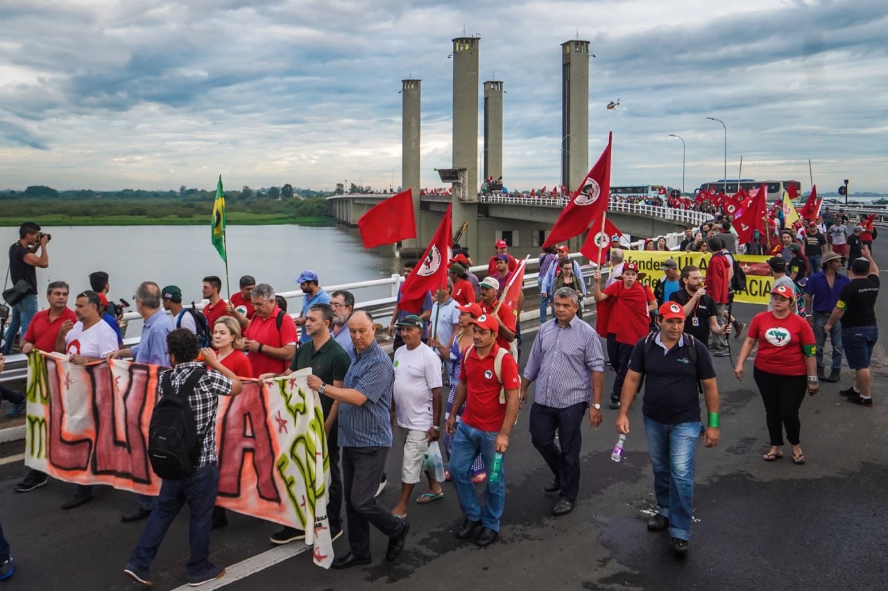 Protesters linked to the Landless Workers Movement (MST) and Via Campesina march at the entrance of Porto Alegre, southern Brazil, 22 January 2018, JEFFERSON BERNARDES/AFP/Getty Images