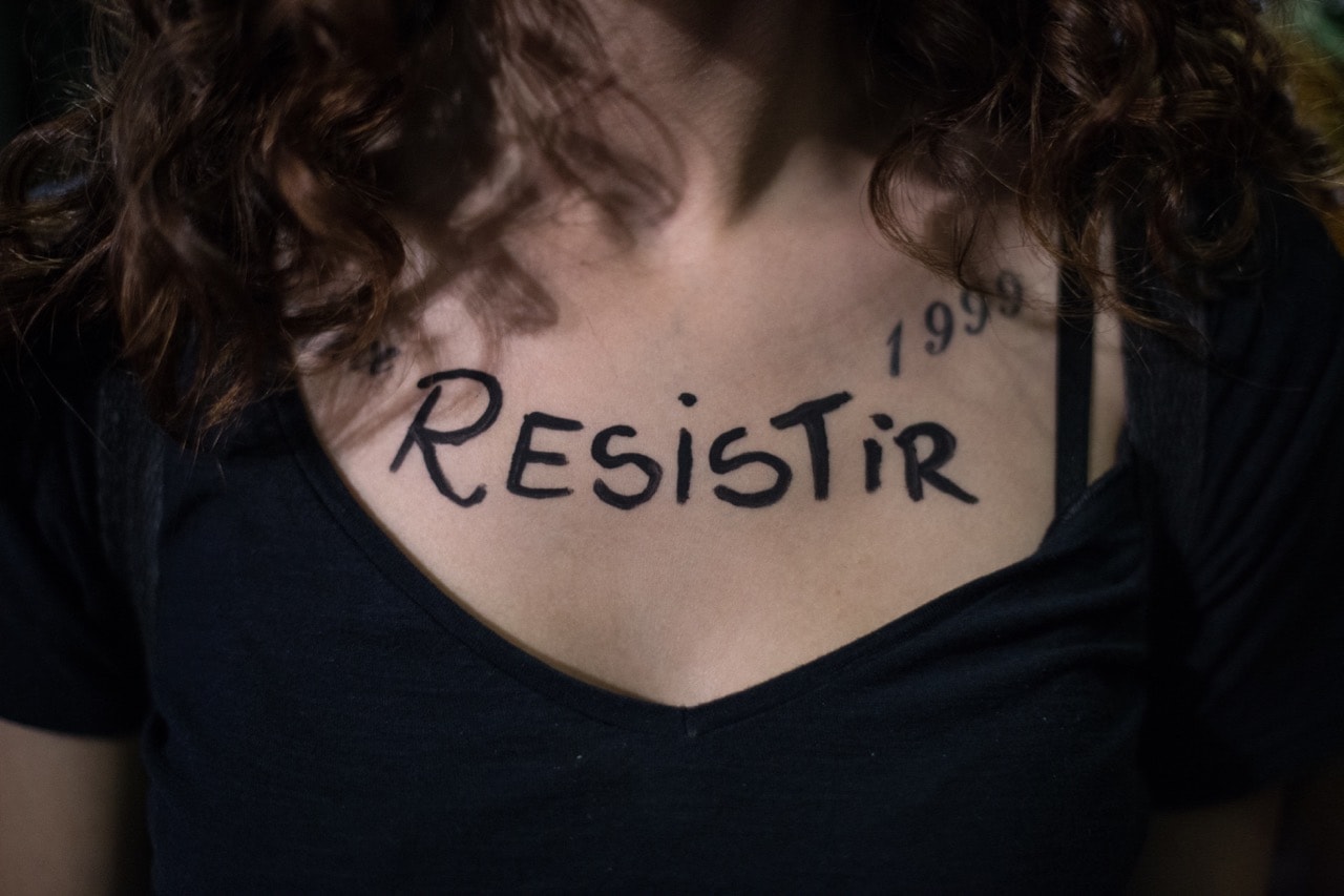 'Resistir' (resist) a demonstrator has written on her chest in a protest against the new president Bolsonaro, in Sau Paolo, 30 October 2018, Andre Lucas/picture alliance via Getty Images