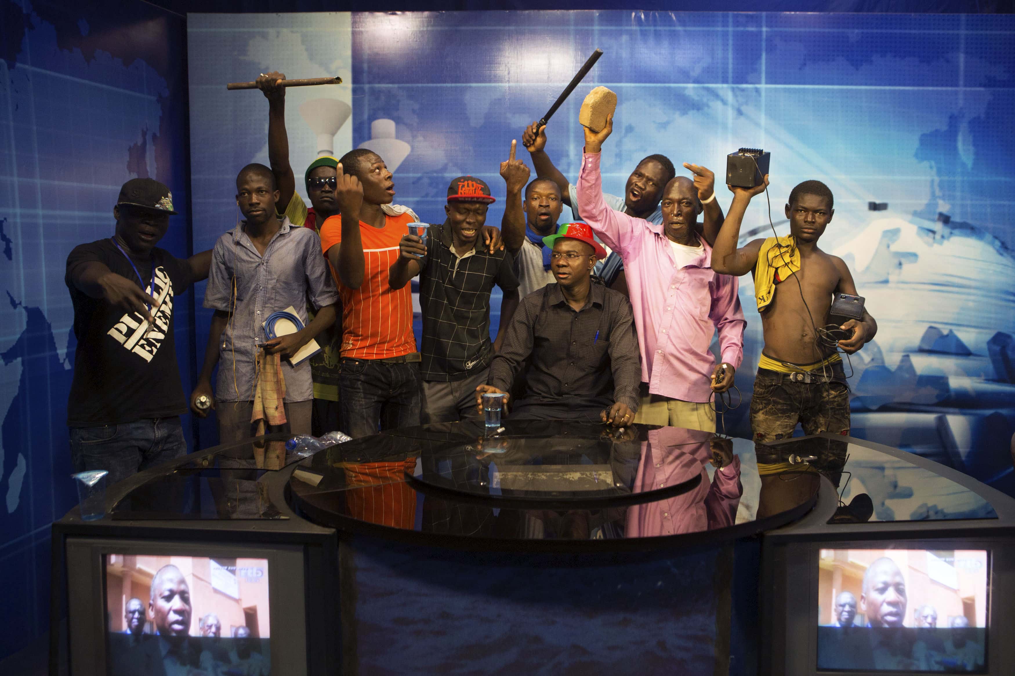 Anti-government protesters take over the state TV podium in Ouagadougou, capital of Burkina Faso, 30 October 2014, REUTERS/Joe Penney