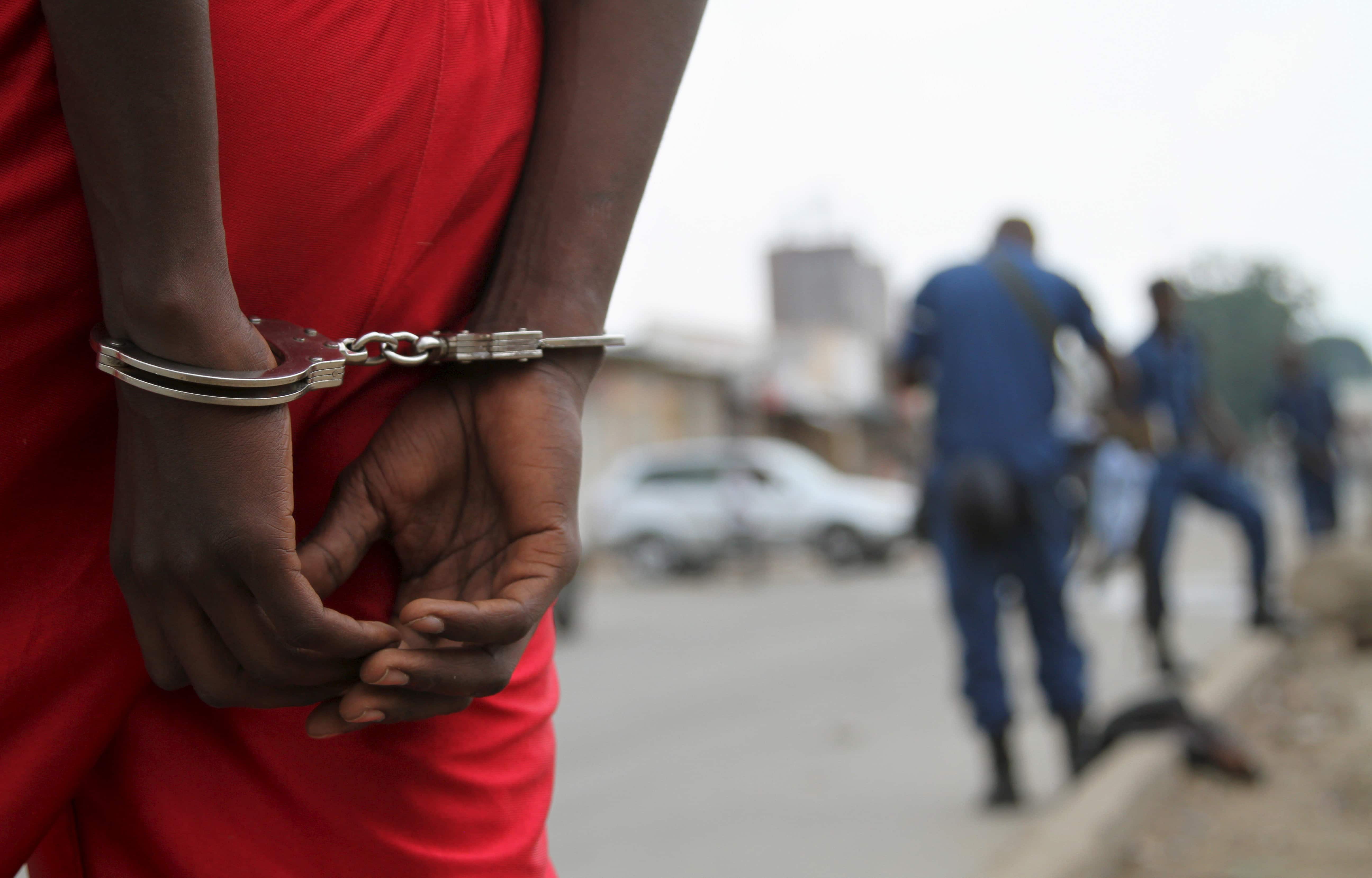 A suspect is handcuffed and detained by policemen after a grenade attack of Burundi's capital Bujumbura, 3 February 2016, REUTERS/Jean Pierre Aime Harerimama