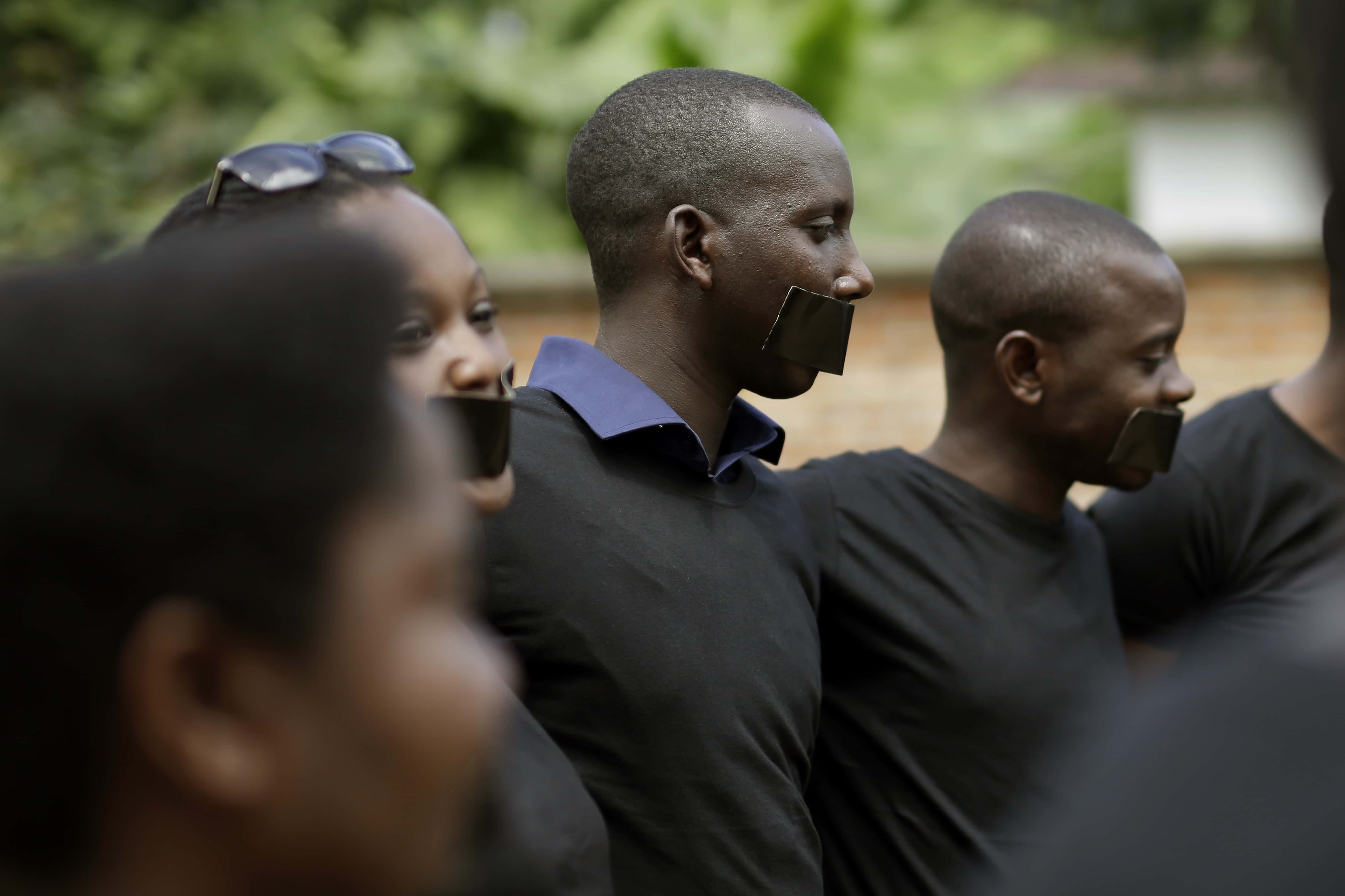 Journalists with tape on their mouths gather on the occasion of World Press Freedom Day, in Bujumbura, Burundi, 3 May 2015, AP Photo/Jerome Delay