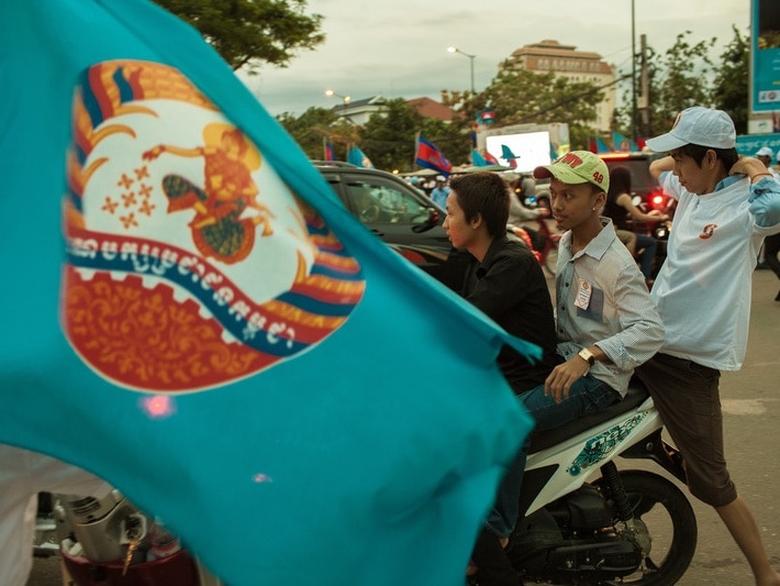 Members of the CPP's (Cambodia People's Party) Youth movement join a parade through the streets of Phnom Penh, 6 July 2013, Demotix/Thomas Cristofoletti