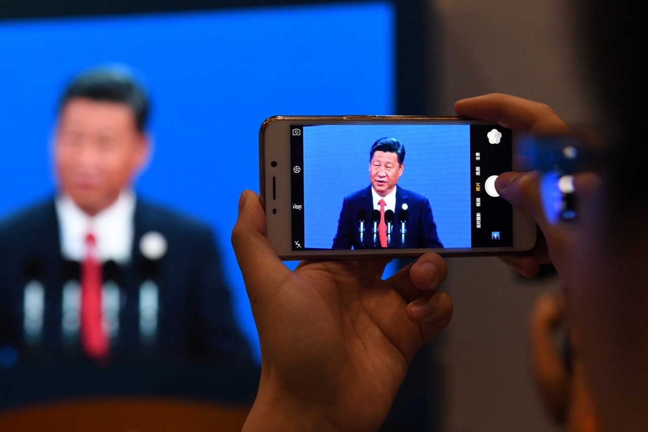 A journalist takes a photo of a live feed of President Xi Jinping at the China National Convention Center in Beijing, 14 May 2017, GREG BAKER/AFP/Getty Images