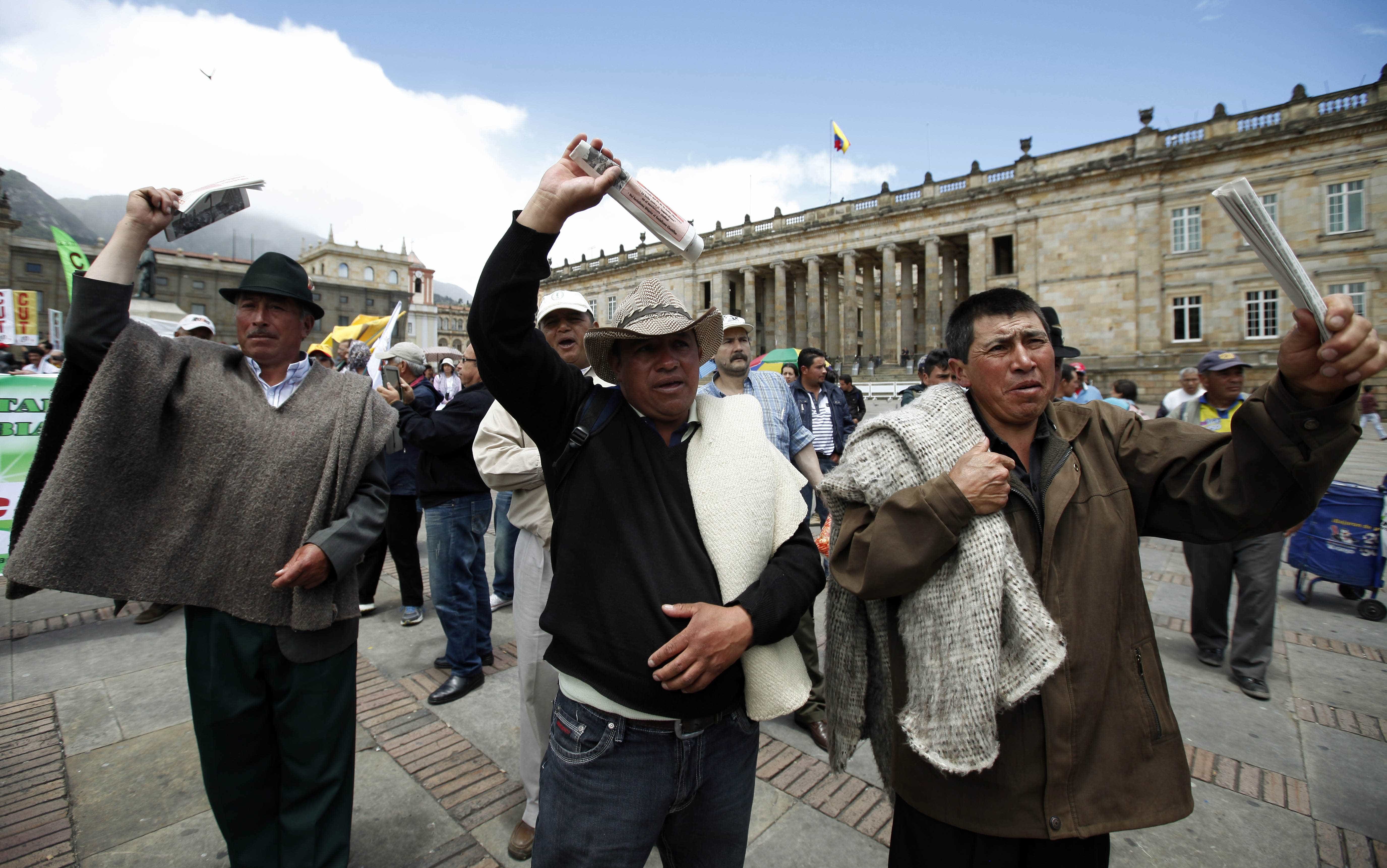 Farmers shout anti-government slogans on Plaza de Bolivar during a demonstration in support of a national strike in Bogota, Colombia, AP Photo/Fernando Vergara