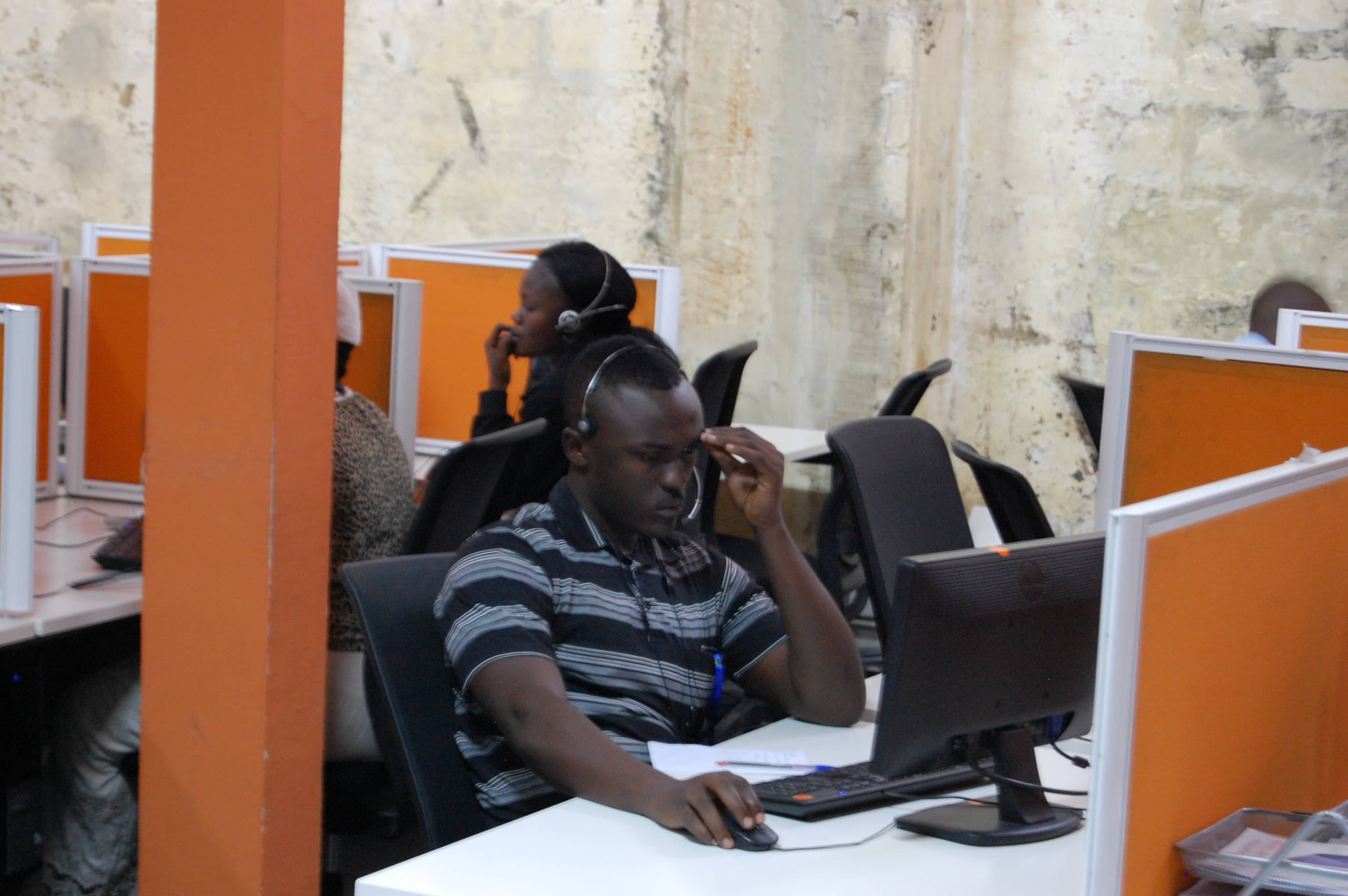 Congolese agents speak on the phone, inside the Congo Call Center, Kinshasa, DRC, 26 July 2016, REUTERS/Aaron Ross