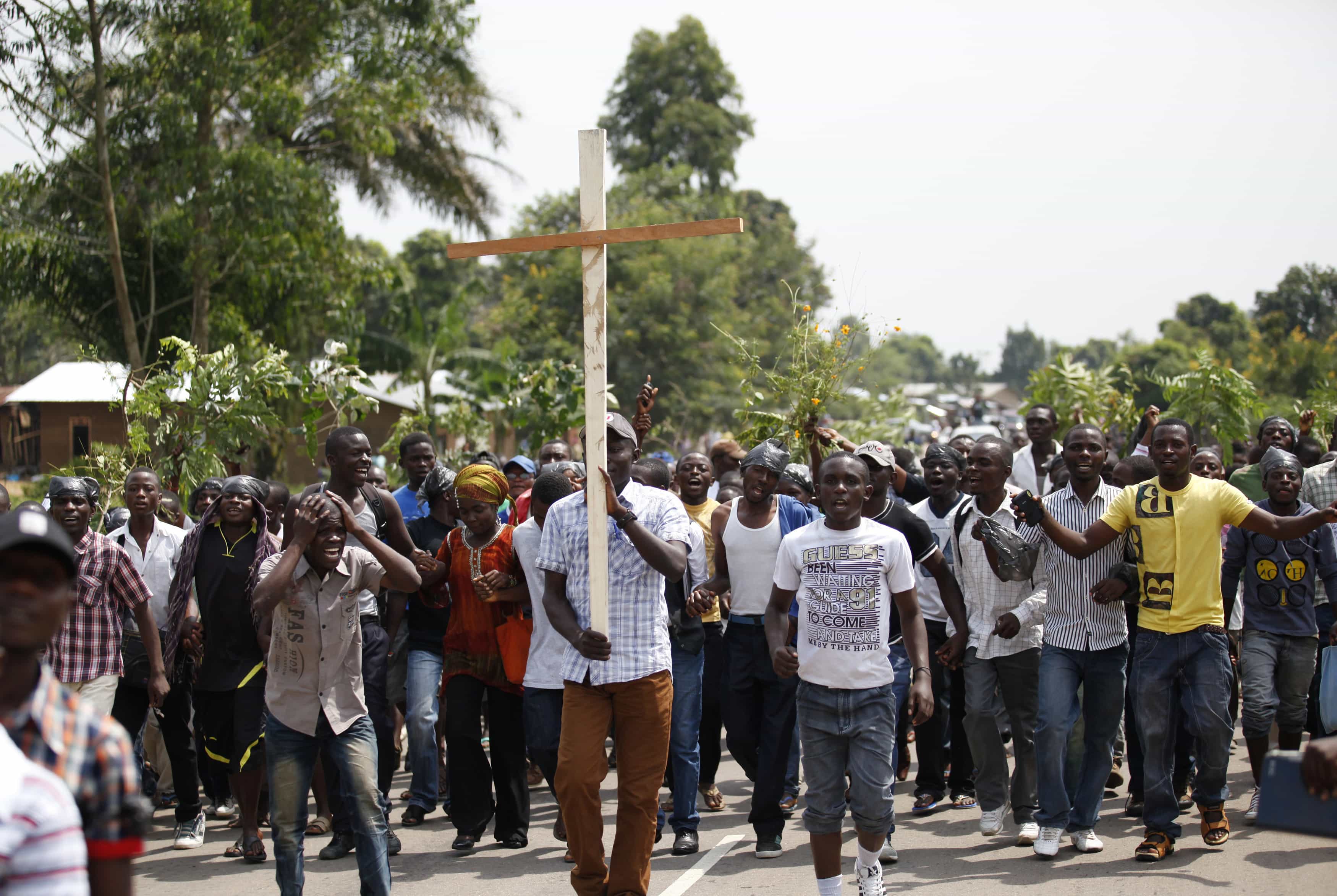 Residents participate in a peaceful demonstration near the scene of a military ambush near the village of Mazizi in North Kivu, 6 January 2014., REUTERS/Kenny Katombe