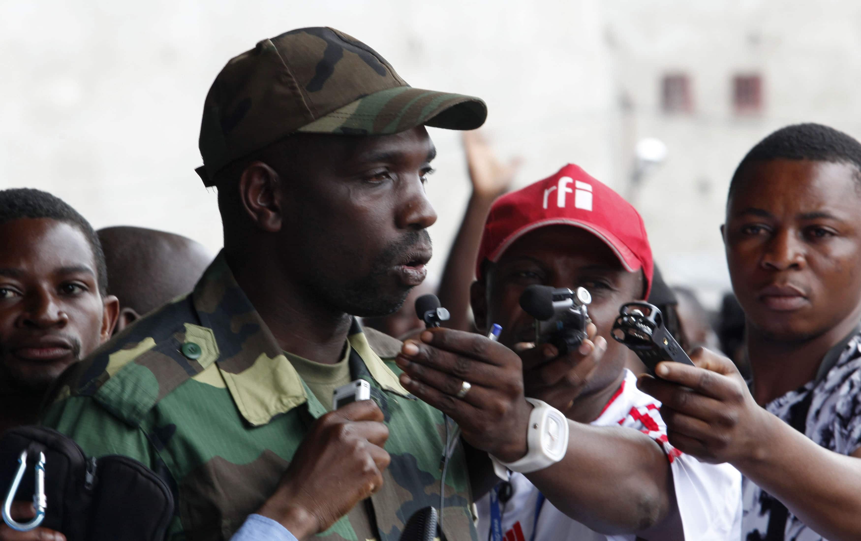 The M23 rebels spokesperson Vianney Kazarama (C) speaks to the media at a stadium in Goma, 21 November 2012., REUTERS/James Akena