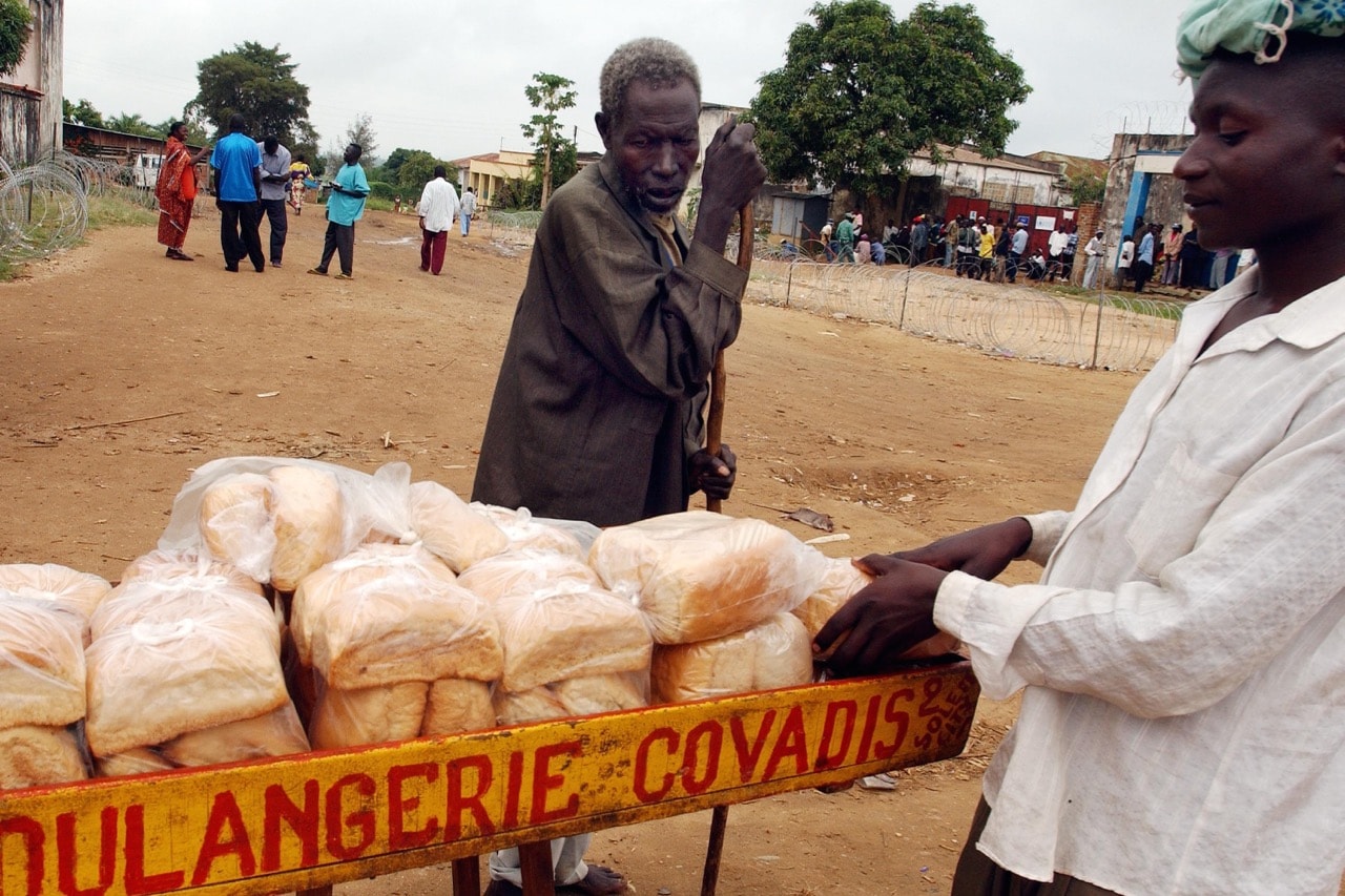 A man looks at loaves of bread for sale in Bunia, Ituri province in Democratic Republic of the Congo, 5 June 2003, Spencer Platt/Getty Images