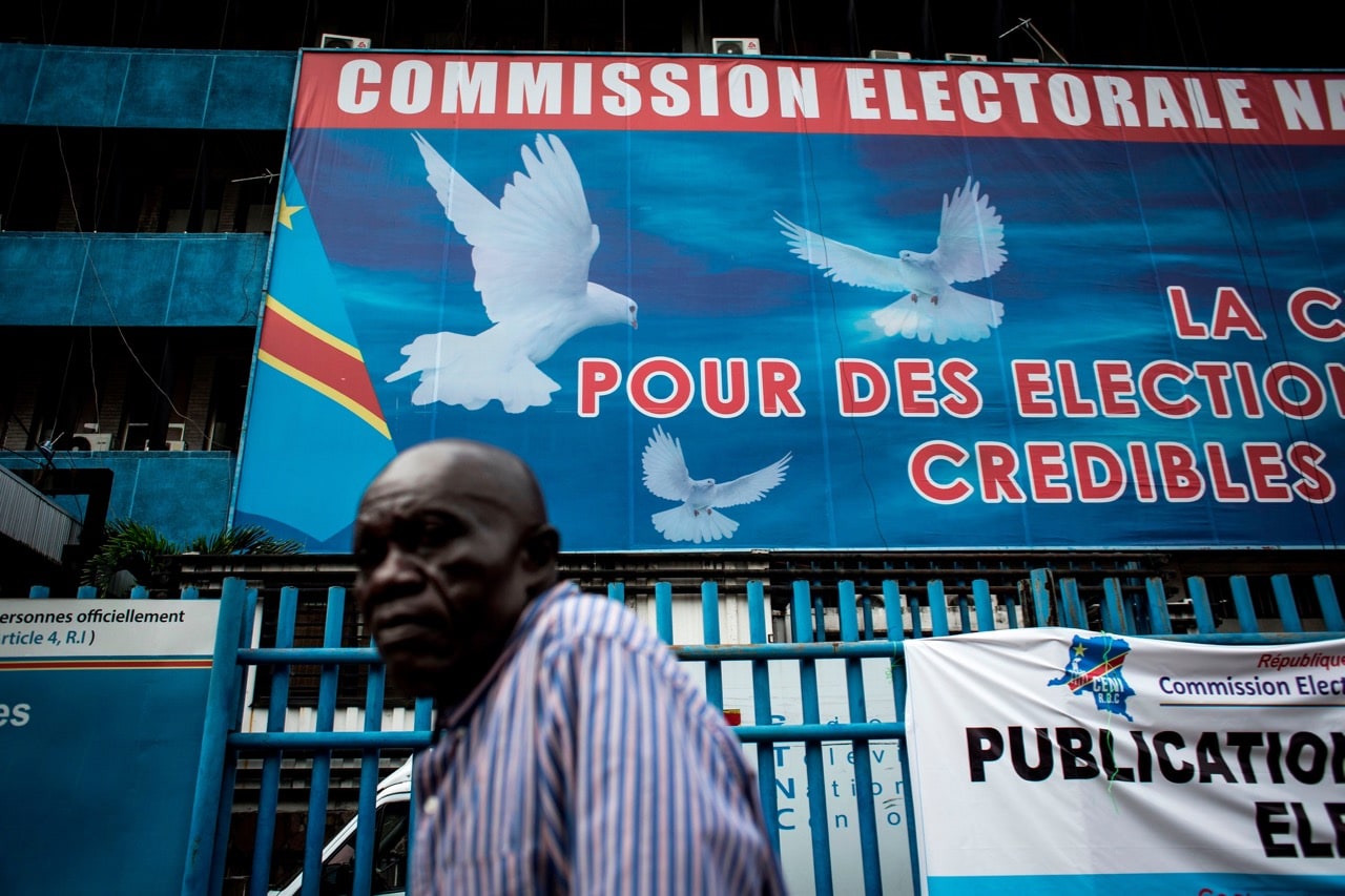 A man walks in front of the Commission Electorale Nationale Independante (CENI) headquarters on 5 November 2017 in Kinshasa, following an announcement of the new electorial calendar for 2018 elections, JOHN WESSELS/AFP/Getty Images