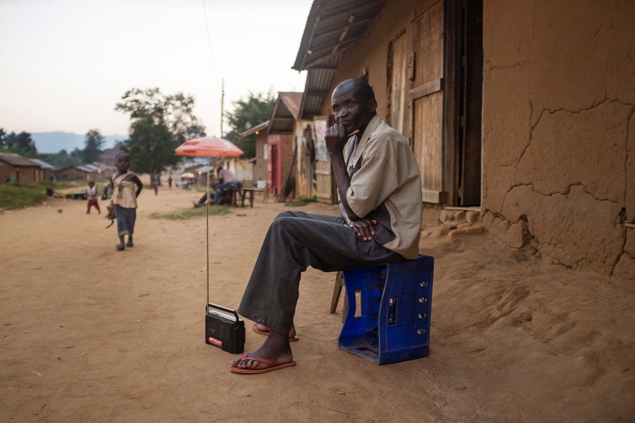 A man listens to the radio on the streets of Luofu, North Kivu province, DRC, 15 July 2016, EDUARDO SOTERAS/AFP/Getty Images