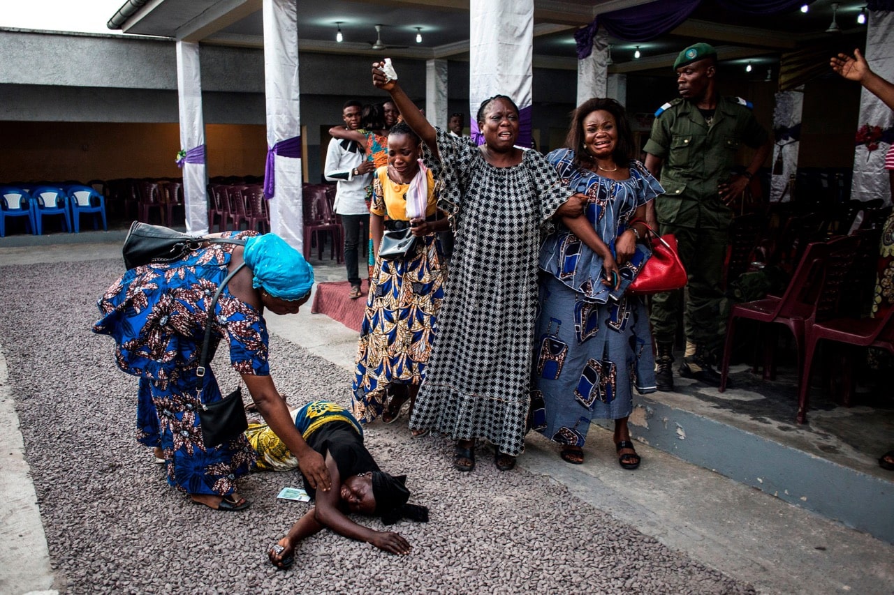 Family members of a person killed in protests on 31 December 2017 react as their relatives' coffin arrives from the morgue on 11 January 2018, in Kinshasa, Democratic Republic of Congo, JOHN WESSELS/AFP/Getty Images