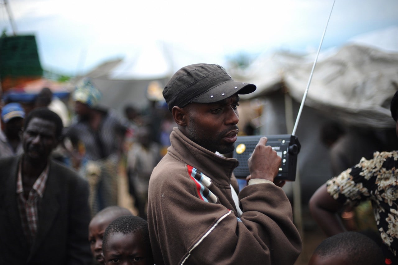 A man listens to news on the radio on the outskirts of the North Kivu town, DRCongo, 7 November 2008, ROBERTO SCHMIDT/AFP/Getty Images