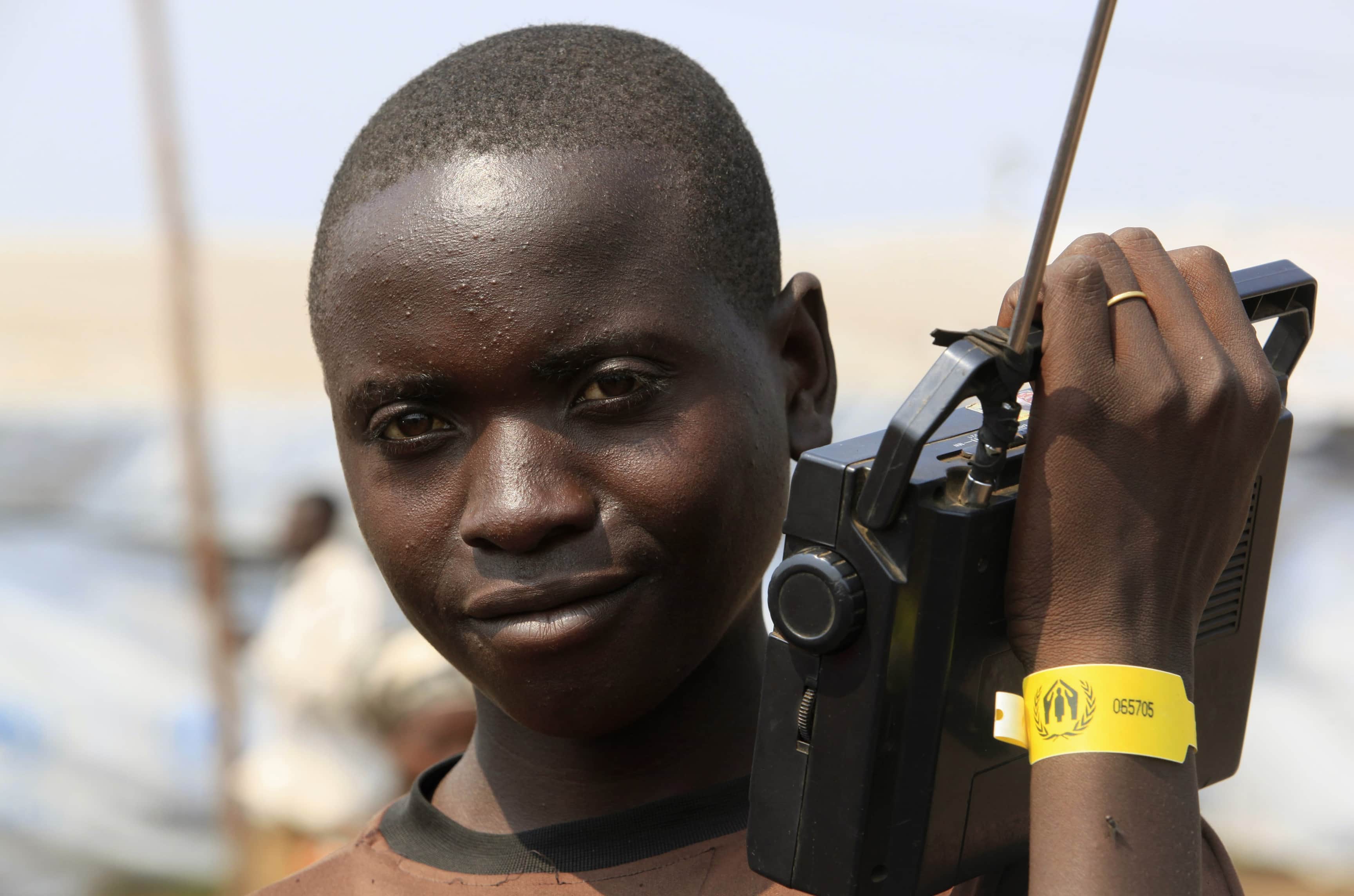 A Congolese boy listens to the radio at the Nyakabande refugee transit camp in Uganda, 8 July 2012, REUTERS/James Akena