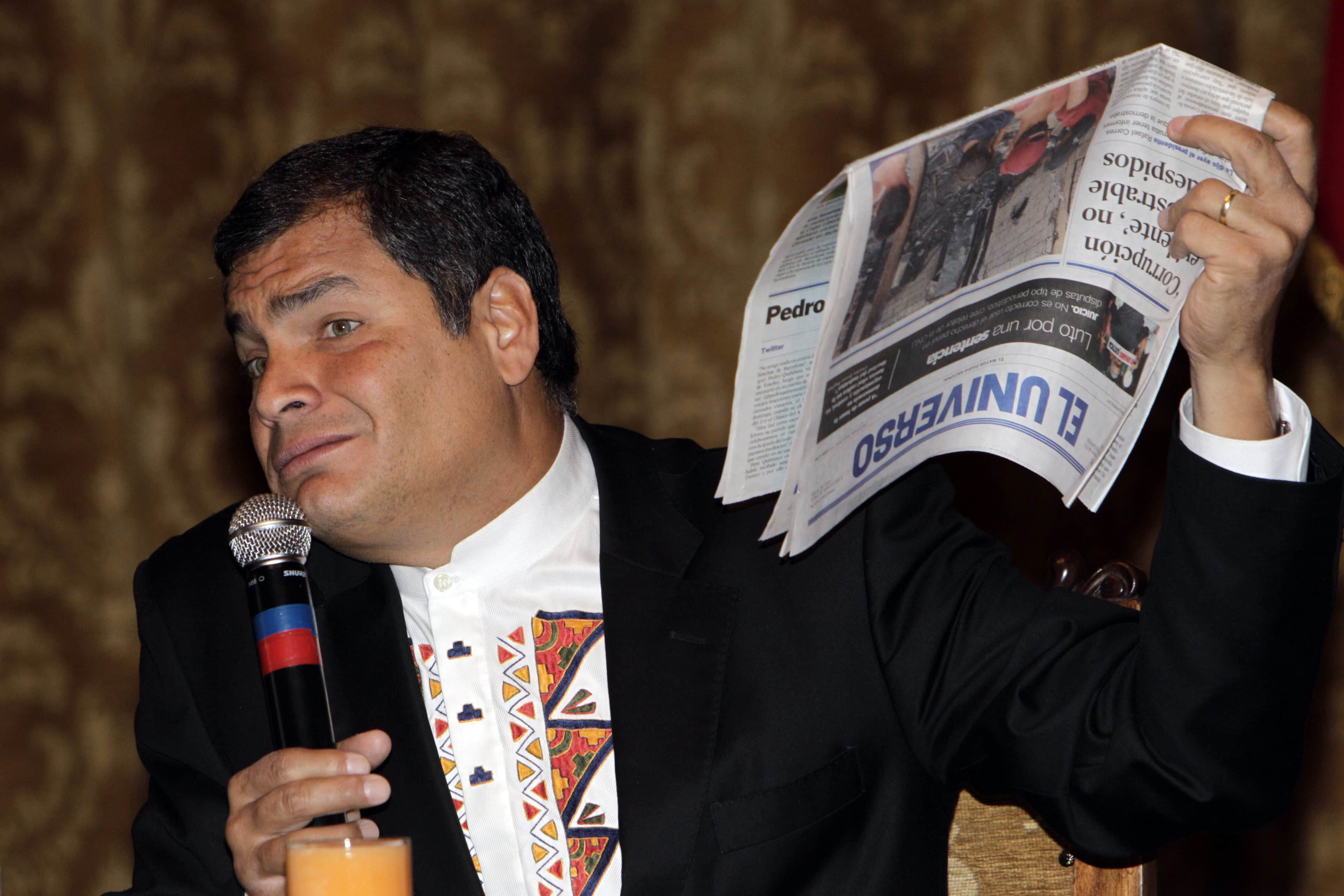 Ecuador's President Rafael Correa holds up a copy of the opposition newspaper El Universo, AP Photo/Dolores Ochoa